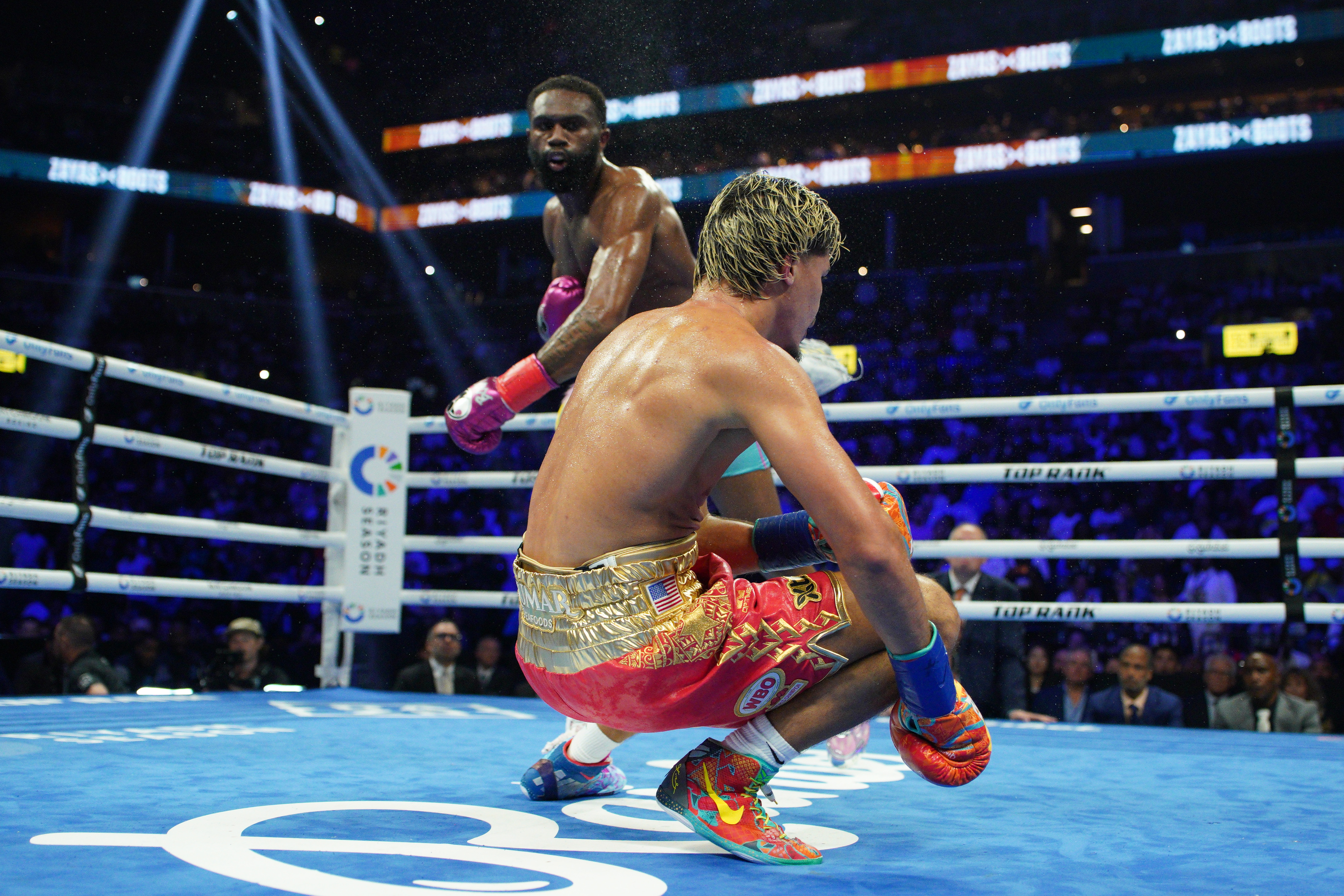 NEW YORK, NEW YORK - JUNE 27: Xander Zayas is knocked down by Jaron 'Boots' Ennis during their WBO and WBA World Super-Welterweight title bout at Barclays Center on June 27, 2026 in New York City. (Photo by Evan Bernstein/Getty Images)