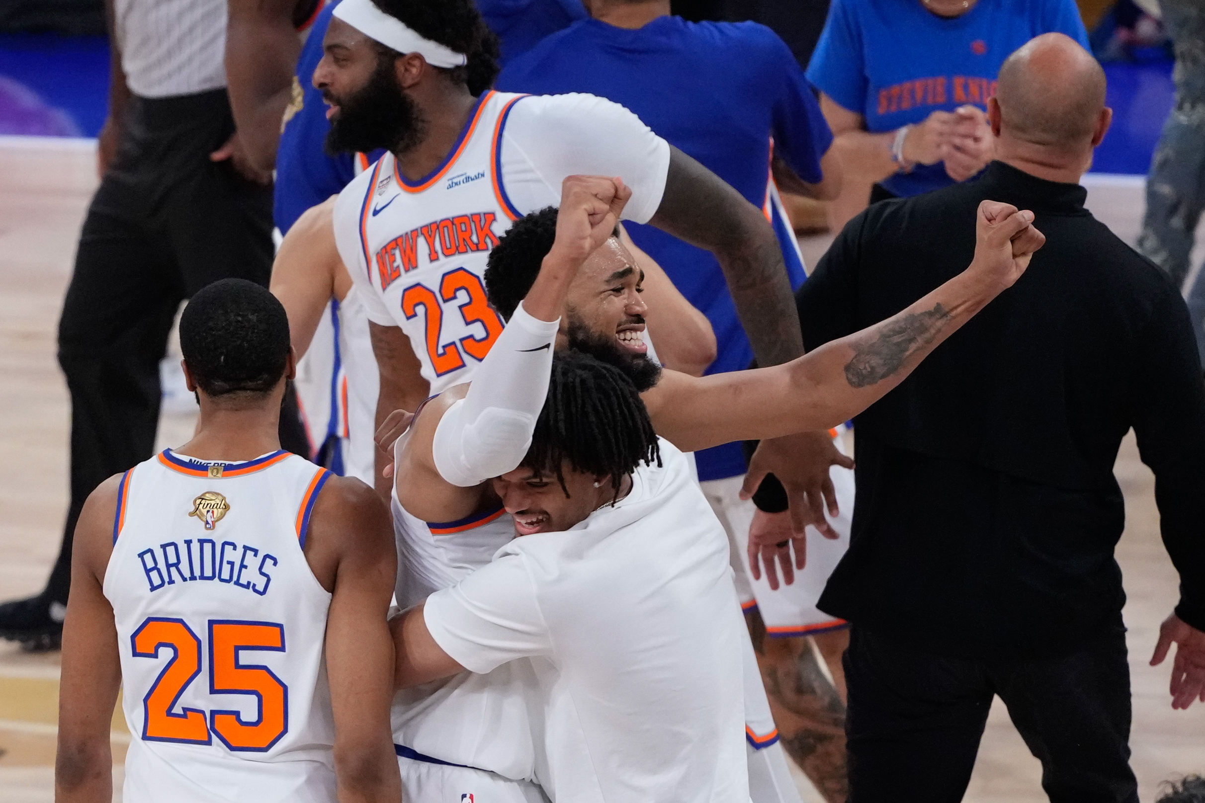 New York Knicks center Karl-Anthony Towns celebrates with guard Mikal Bridges (25) and enter Mitchell Robinson (23) after Game 4 of the NBA Finals basketball series against the San Antonio Spurs, Wednesday, June 10, 2026, in New York. (AP Photo/Ross D. Franklin)