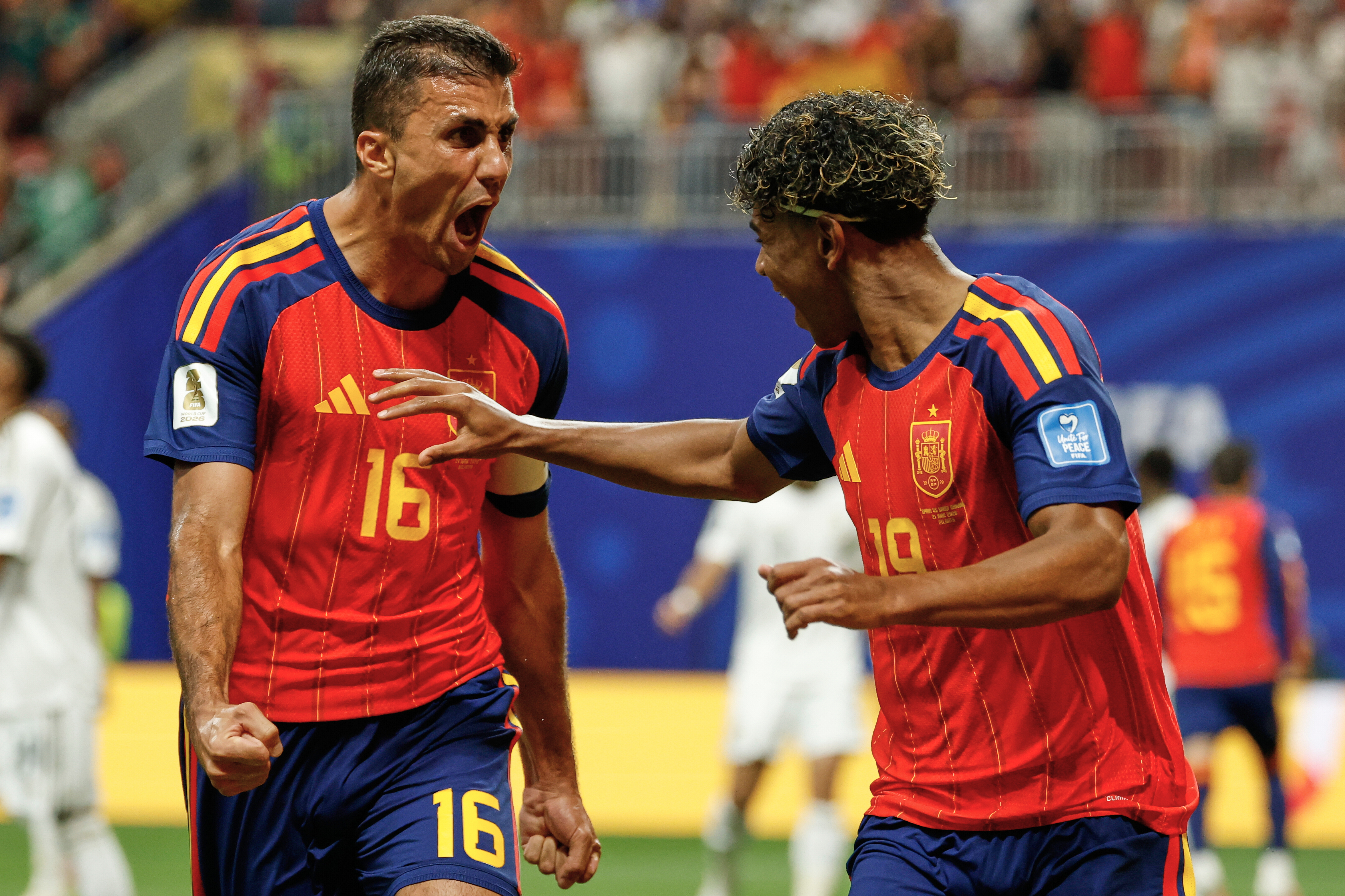 Spain's Lamine Yamal celebrates with teammate Rodri, left, after scoring his side's opening goal during the World Cup Group H soccer match between Spain and Saudi Arabia in Atlanta, Sunday, June 21, 2026. (AP Photo/Erik S.Lesser)