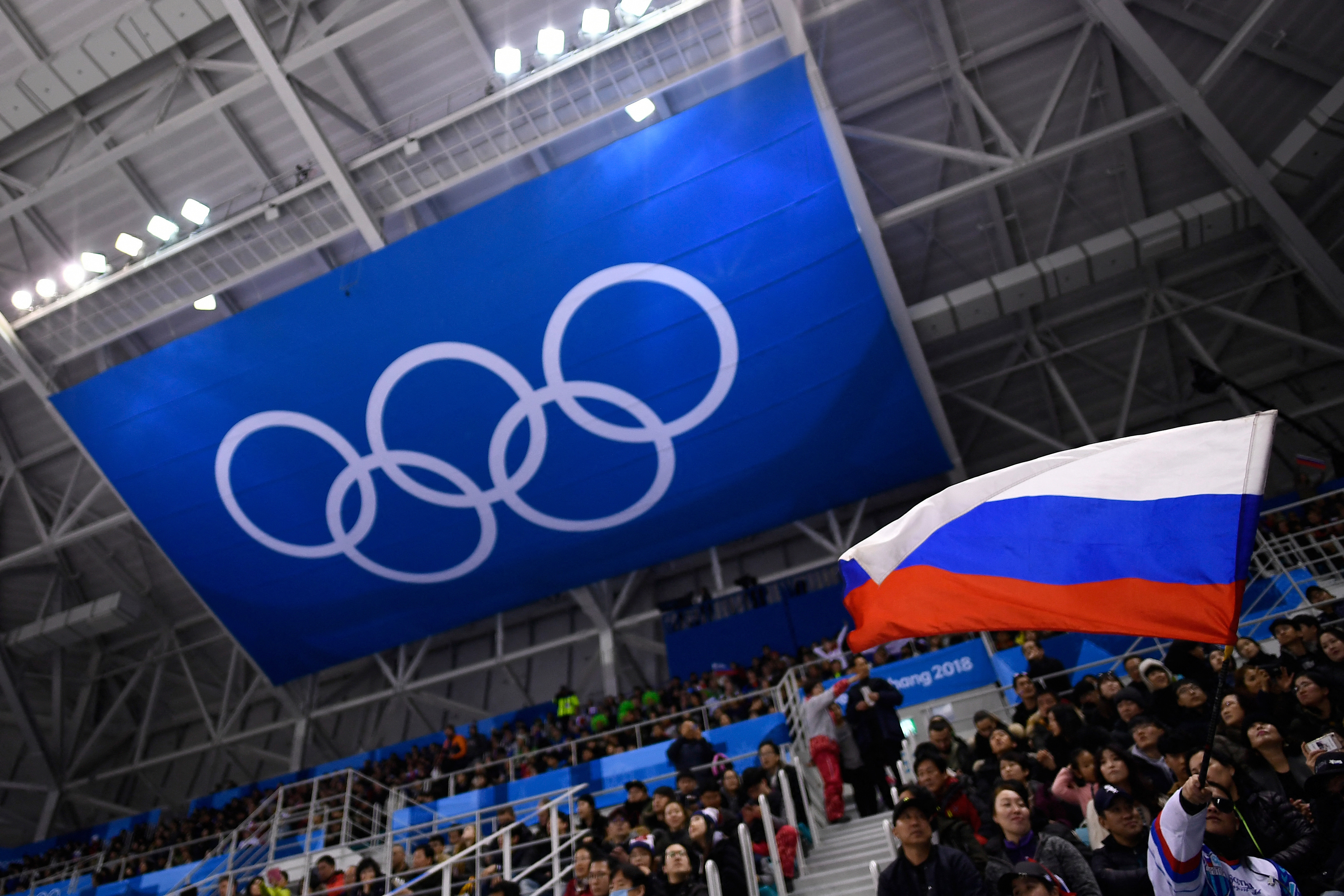 A spectator waves the Russia flag during the men's preliminary round ice hockey match between the Olympic Athletes from Russia and Slovenia during the Pyeongchang 2018 Winter Olympic Games at the Gangneung Hockey Centre in Gangneung on February 16, 2018. (Photo by Brendan Smialowski / AFP via Getty Images)