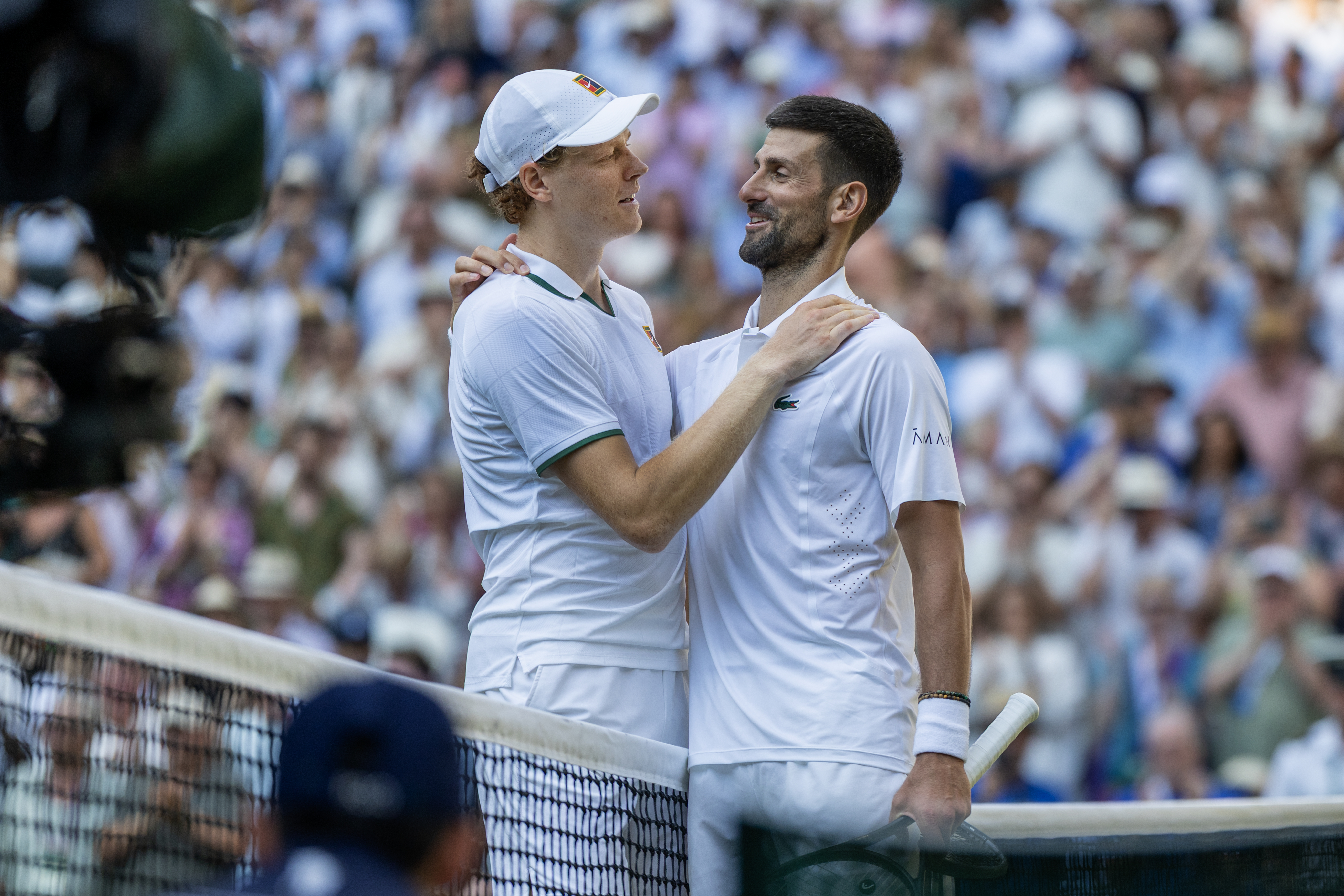 LONDON, ENGLAND - July 10: Winner Jannik Sinner of Italy and Novak Djokovic of Serbia embrace at the net after they match in the semi-final of the Gentlemen's Singles Competition on Centre Court during the Wimbledon Lawn Tennis Championships at the All England Lawn Tennis and Croquet Club at Wimbledon on July 10th, 2026, in London, England. (Photo by Tim Clayton/Getty Images)