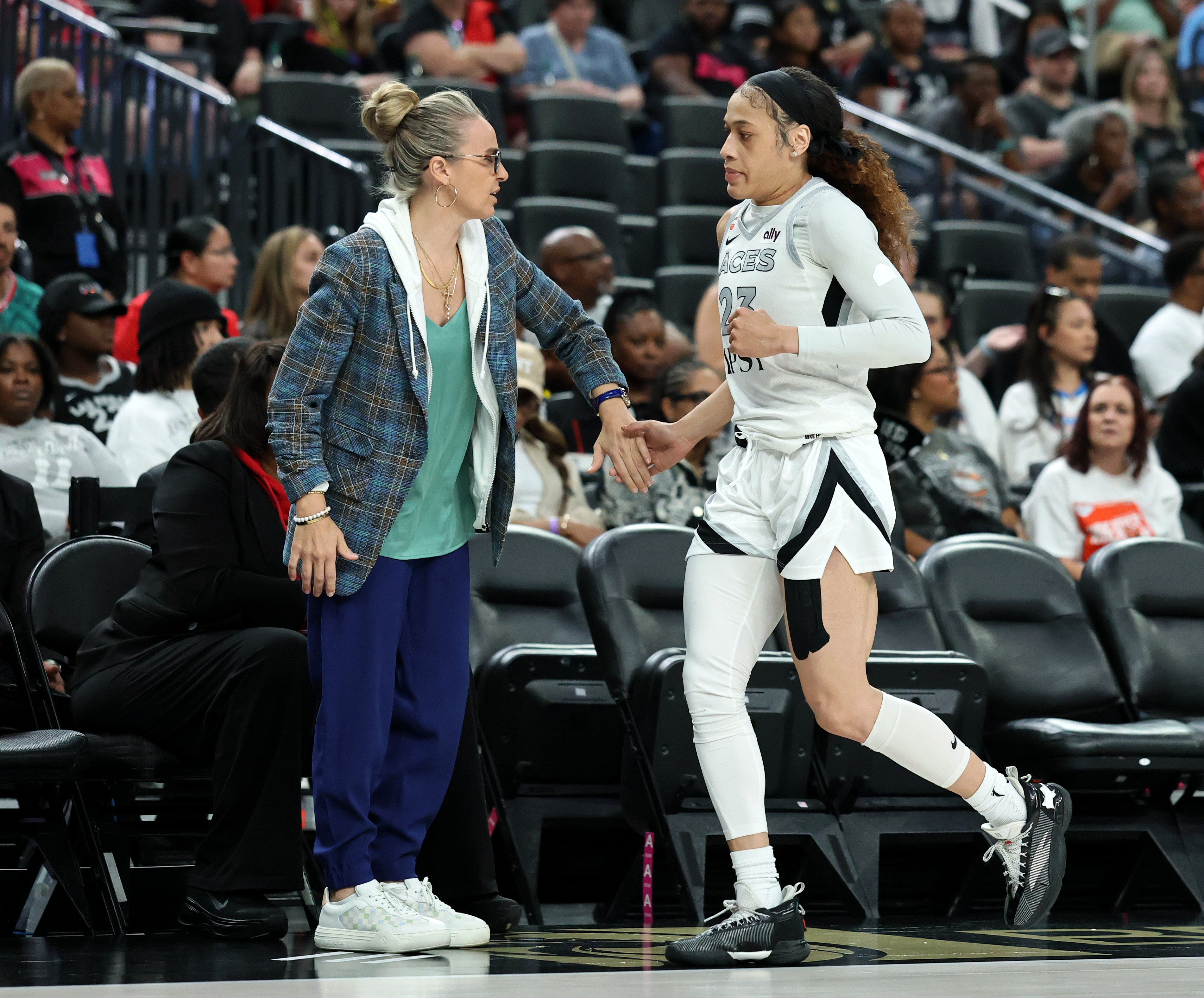 LAS VEGAS, NEVADA - JULY 03: Head coach Becky Hammon of the Las Vegas Aces slaps hands with Chennedy Carter #23 as she checks out in the second quarter of a game against the Chicago Sky at T-Mobile Arena on July 03, 2026 in Las Vegas, Nevada. The Aces defeated the Sky 98-90 in overtime. NOTE TO USER: User expressly acknowledges and agrees that, by downloading and or using this photograph, User is consenting to the terms and conditions of the Getty Images License Agreement. (Photo by Ethan Miller/Getty Images)