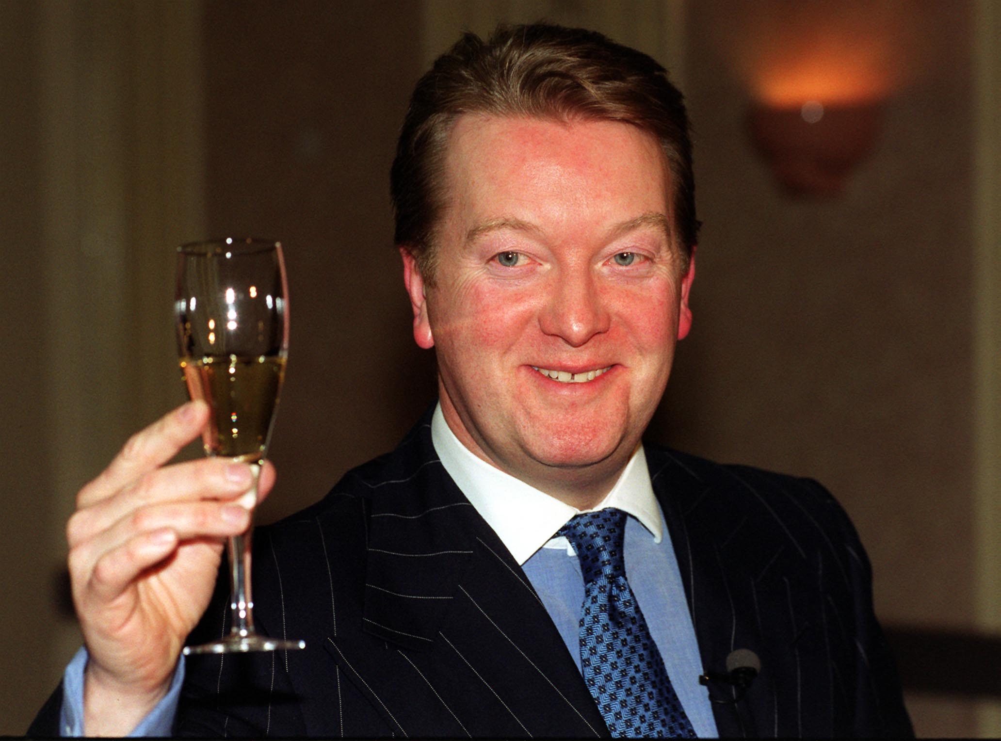 Boxing promoter Frank Warren raises a glass of champagne at a press conference in London, after hearing that the home secretary, Jack Straw was allowing American boxer Mike Tyson's entry into Britain. 22/02/00: Warren wins Best Dressed award.  * 22/02/2000: Warren named as Britain's Best Dressed Businessman by the Menswear Council.   (Photo by Michael Stephens - PA Images/PA Images via Getty Images)