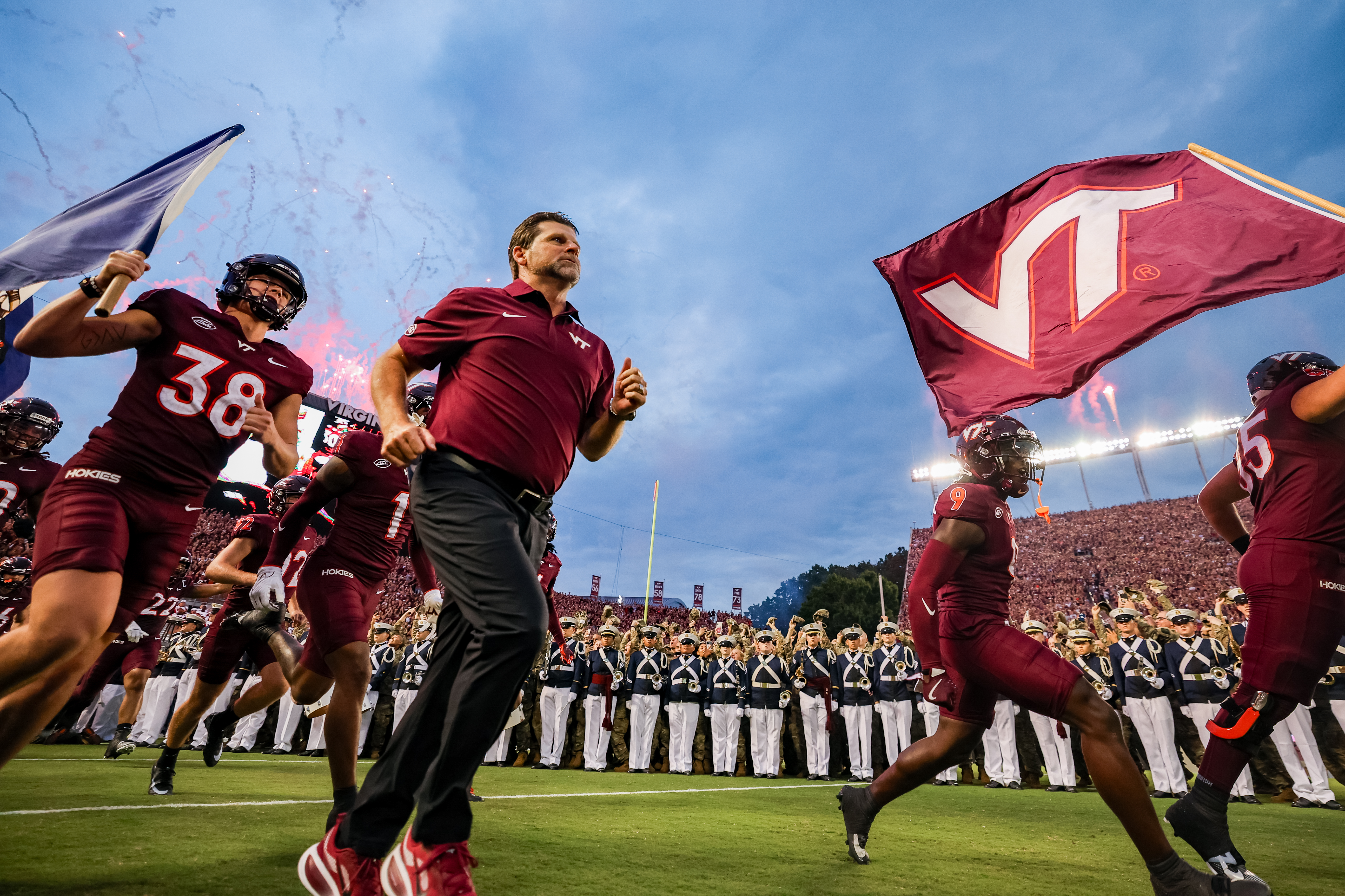 BLACKSBURG, VIRGINIA - SEPTEMBER 6: Head coach Brent Pry of the Virginia Tech Hokies runs onto the field with Kyle Lowe #38 of the Virginia Tech Hokies carrying the Virginia state flag prior to the game against the Vanderbilt Commodores at Lane Stadium on September 6, 2025 in Blacksburg, Virginia. (Photo by Ryan Hunt/Getty Images)