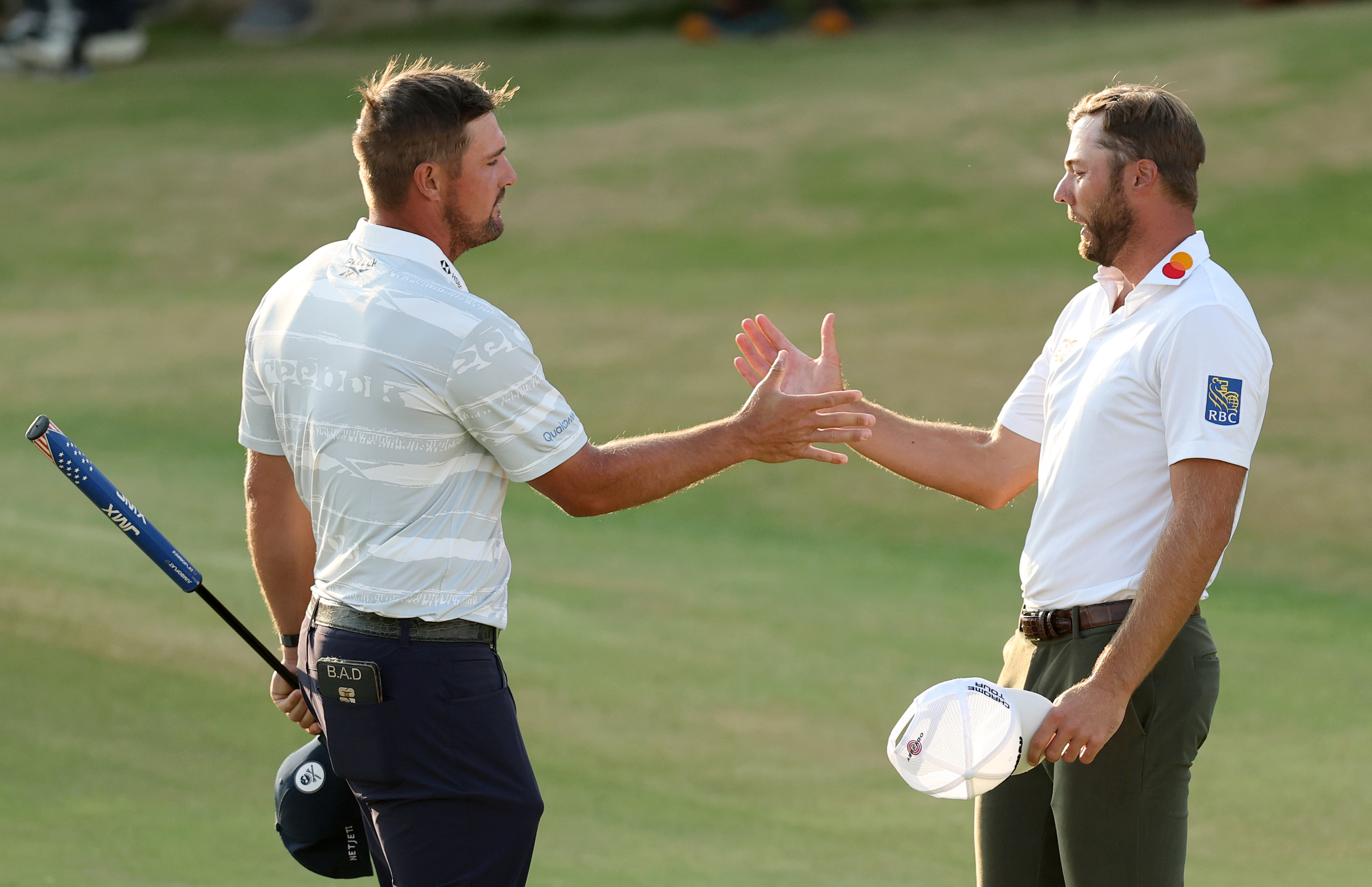 SOUTHPORT, ENGLAND - JULY 18: Bryson DeChambeau of the United States and Sam Burns of the United States shake hands after finishing their round on the 18th green on day three of the The 154th Open Championship at Royal Birkdale on July 18, 2026 in Southport, England. (Photo by Michael Reaves/Getty Images)
