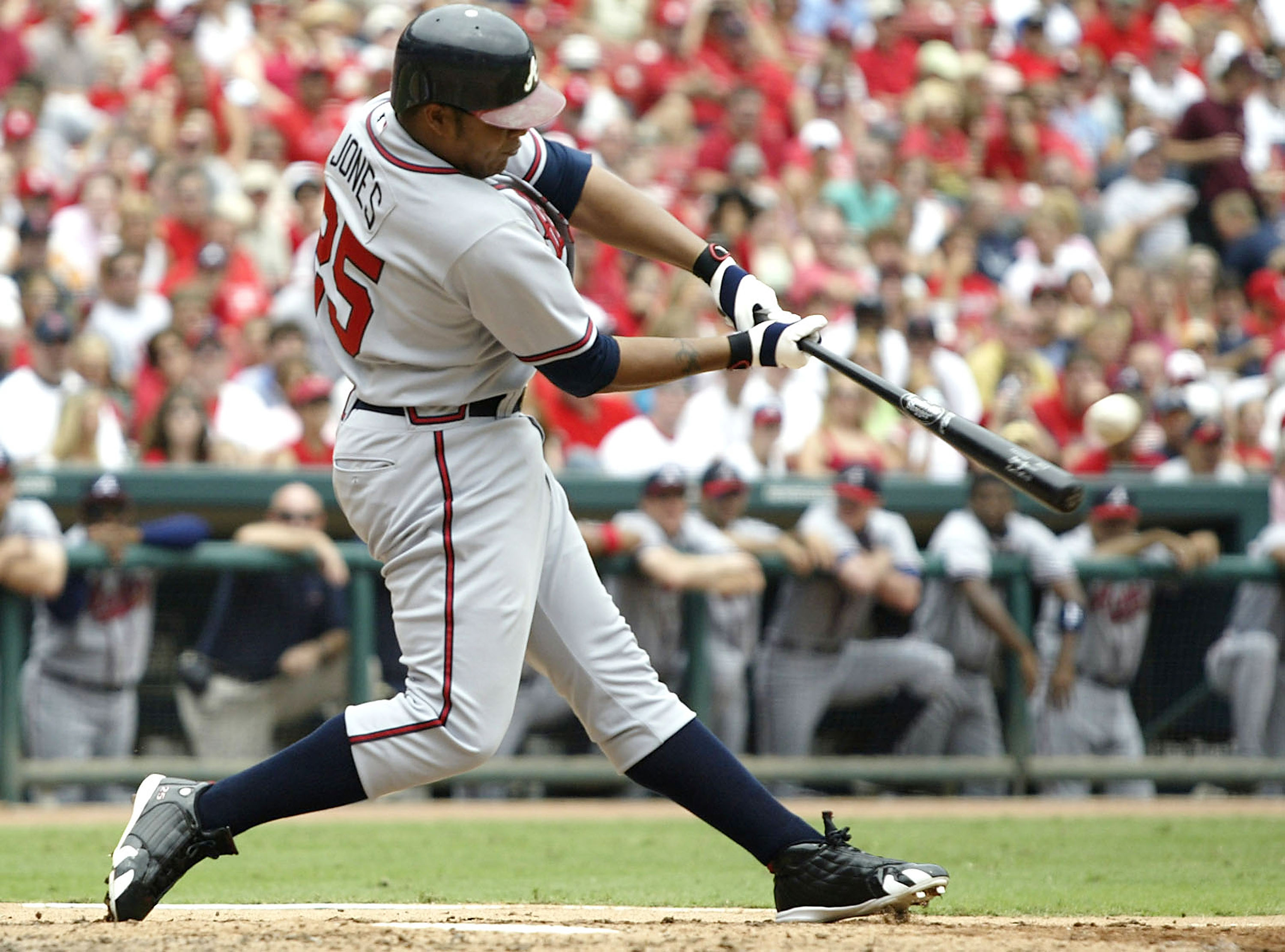 ST. LOUIS - AUGUST 6:  Outfielder Andruw Jones #25 of the Atlanta Braves hits a grand-slam home run against the St. Louis Cardinals on August 6, 2005 at Busch Stadium in St. Louis, Missouri. The Braves defeated the Cardinals 8-1.  (Photo by Dilip Vishwanat/Getty Images)