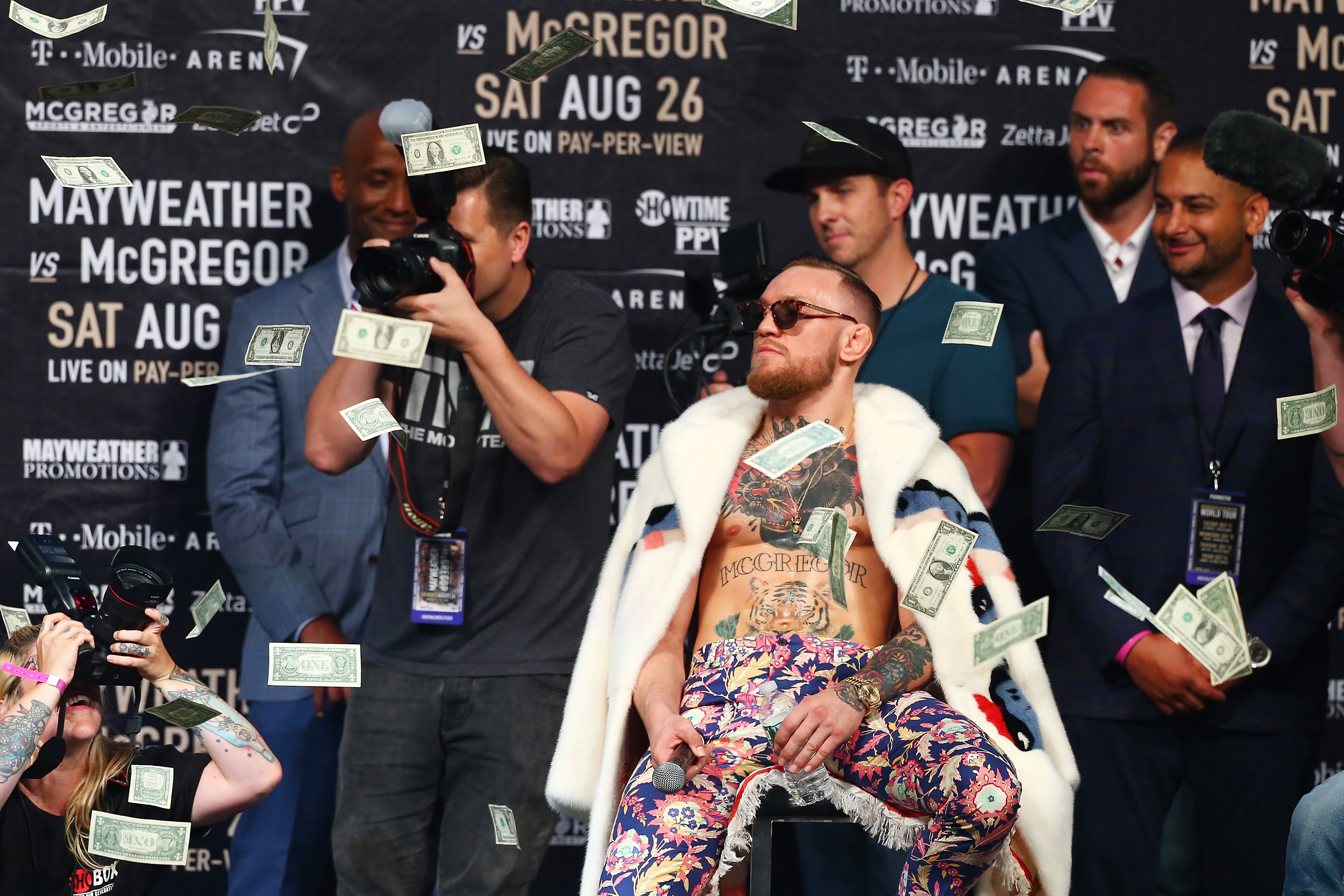 NEW YORK, NY - JULY 13:  Conor McGregor looks on as money rains down during the Floyd Mayweather Jr. v Conor McGregor World Press Tour event at Barclays Center on July 13, 2017 in the Brooklyn borough of New York City.  (Photo by Mike Stobe/Getty Images)