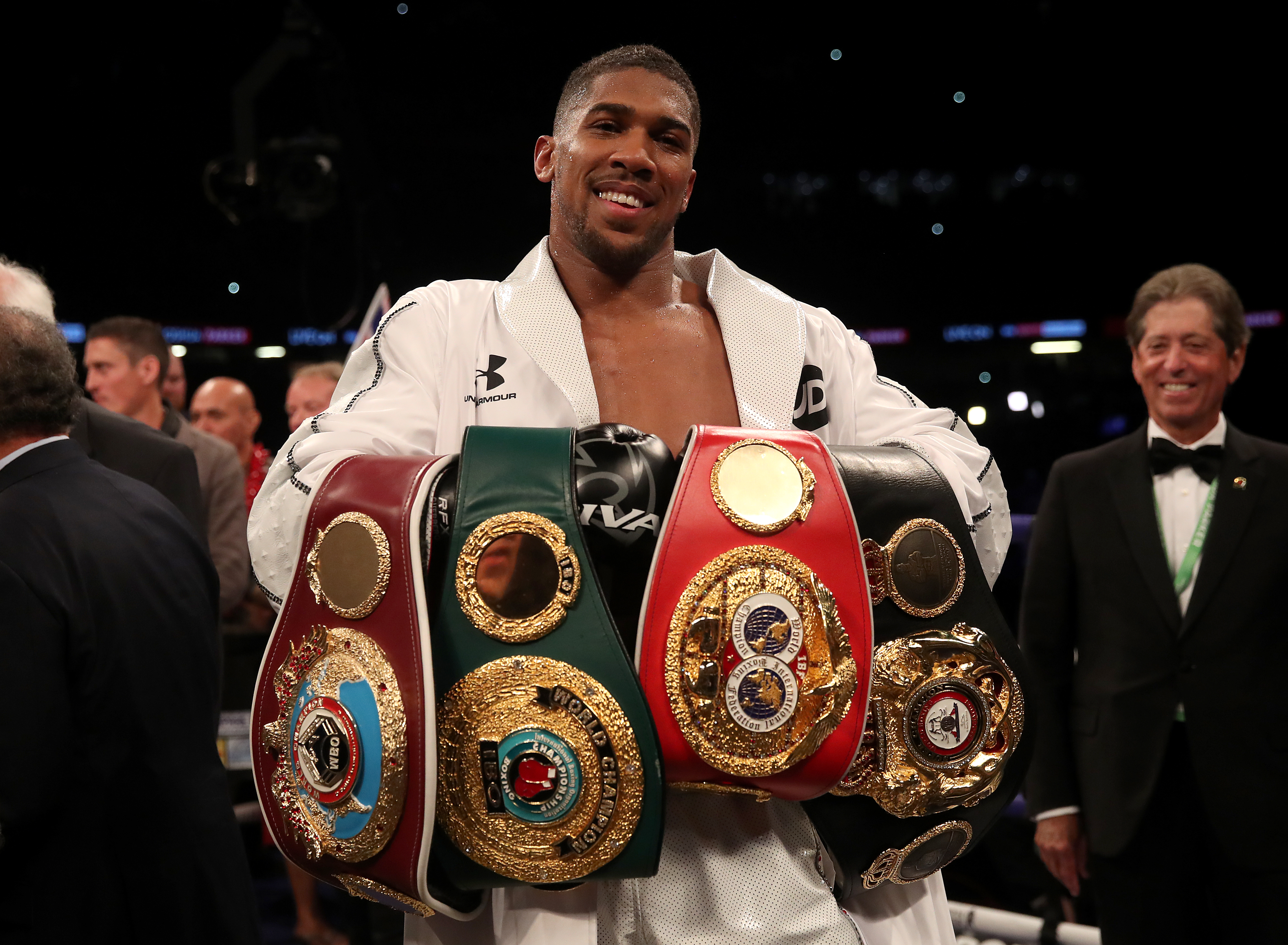 Anthony Joshua celebrates with his belts after victory over Joseph Parker in their WBA, IBF, WBO and IBO Heavyweight Championship contest at the Principality Stadium, Cardiff. (Photo by Nick Potts/PA Images via Getty Images)
