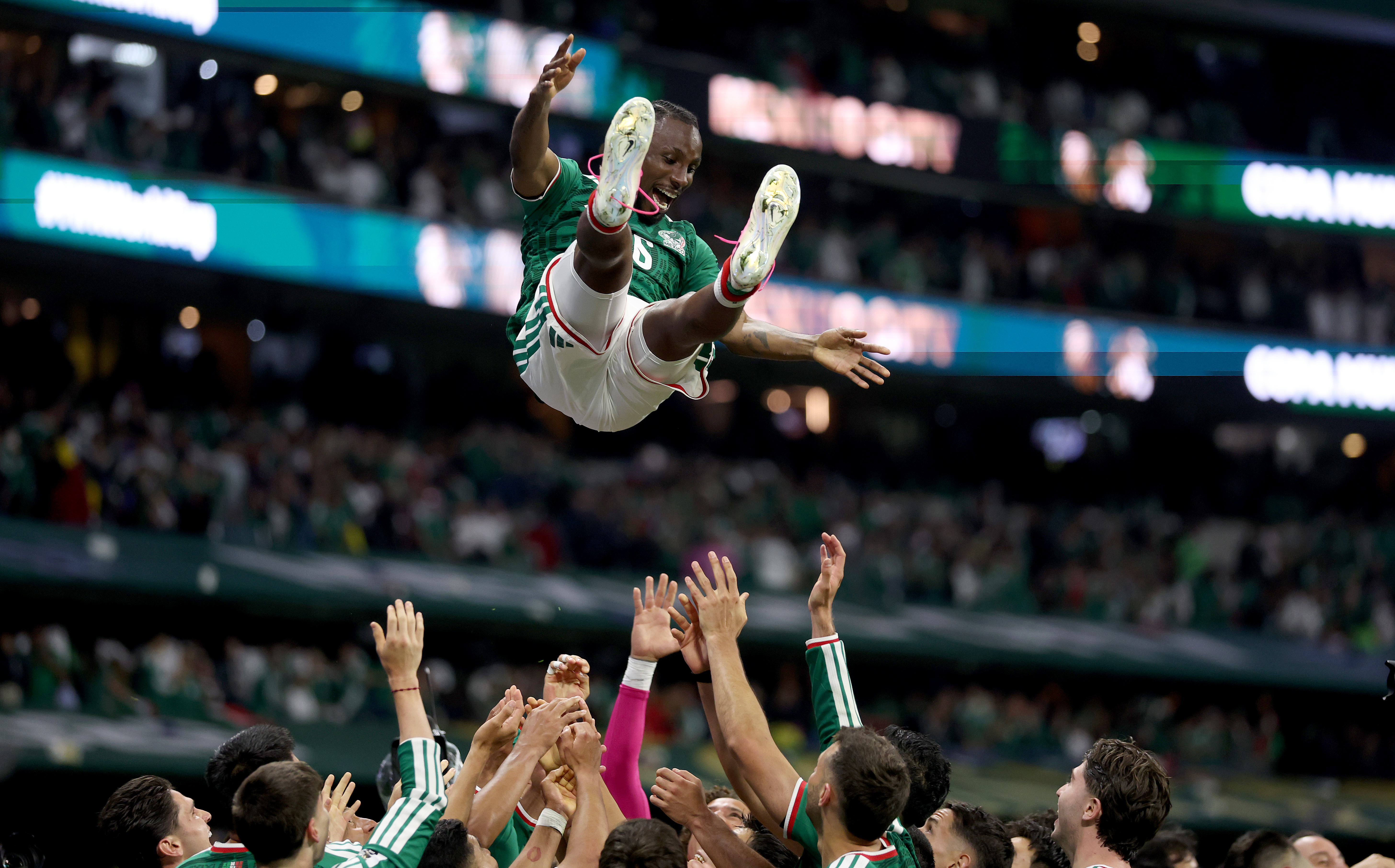 MEXICO CITY, MEXICO - JUNE 30: Julian Quinones #16 of Mexico is thrown in the air by team mates as they celebrate after the team's victory and progression to the Round of 16 after the FIFA World Cup 2026 Round Of 32 match between Mexico and Ecuador at Mexico City Stadium on June 30, 2026 in Mexico City, Mexico. (Photo by Carl Recine/Getty Images)