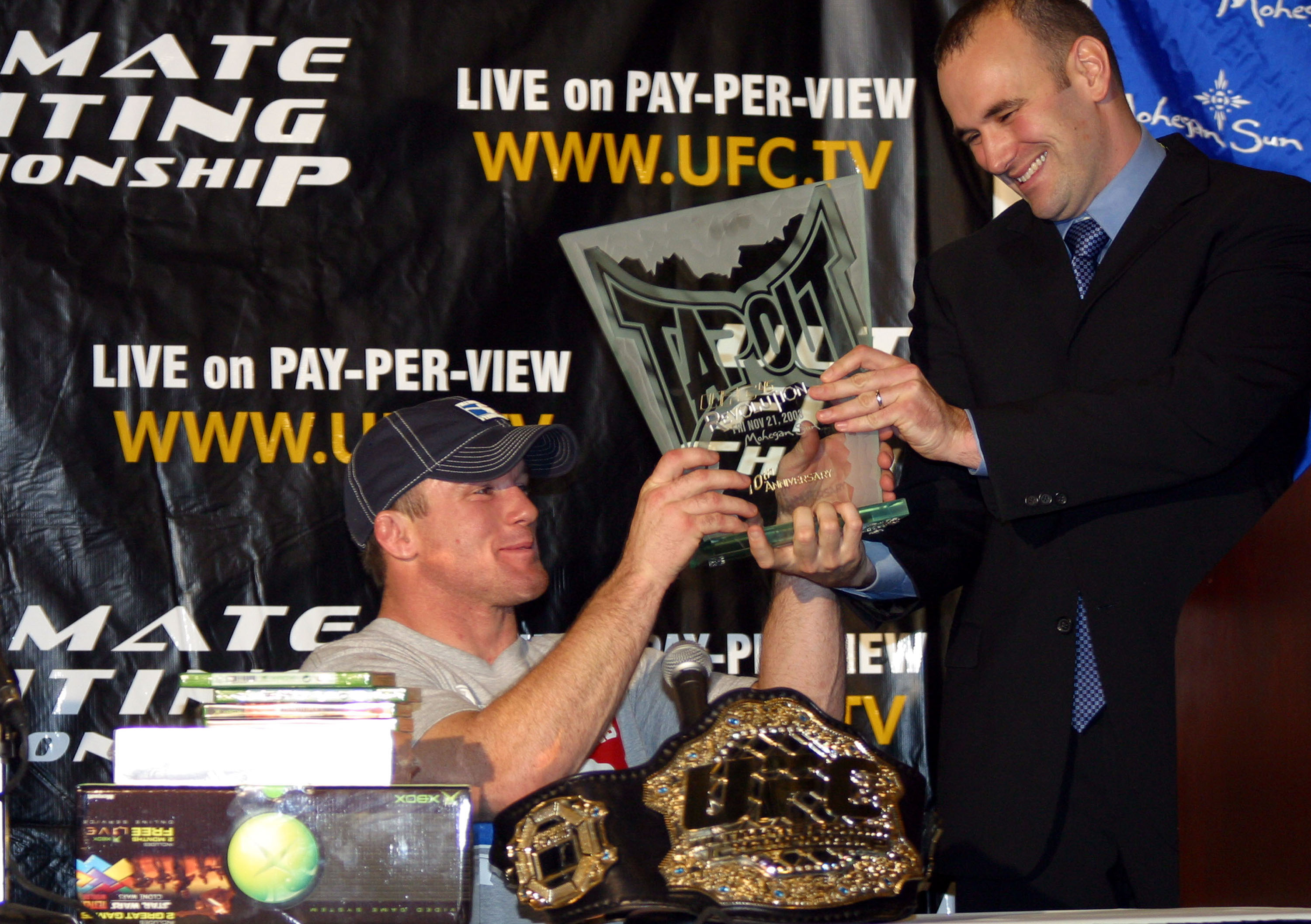 UFC President Dana White presents Welterweight Champion Matt Hughes with the Tapout award for best submission win of the night at UFC 45: Revolution.  Hughes retained his title with a rear naked choke submission win over challenger Frank Trigg. (Photo by Ed Mulholland/WireImage)