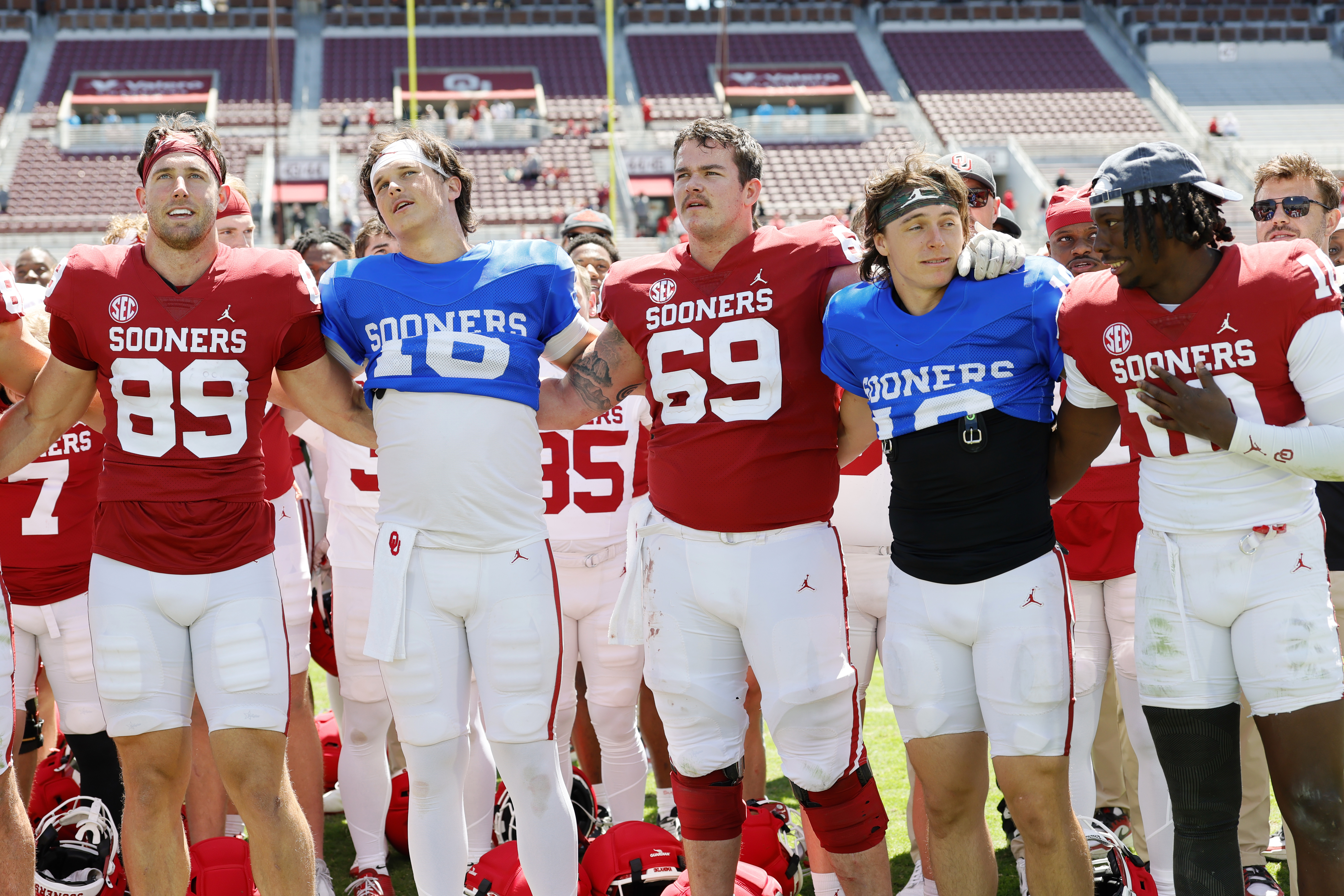 NORMAN, OKLAHOMA - APRIL 18:  Tight end Hayden Hansen #89, quarterback Whitt Newbauer #16, center offensive lineman Jake Maikkula #69, quarterback John Mateer #10, and linebacker Kip Lewis #10 of the Oklahoma Sooners stand for the alma mater during the Spring Game at Gaylord Family Oklahoma Memorial Stadium on April 18, 2026 in Norman, Oklahoma.  (Photo by Brian Bahr/Getty Images for ONIT)