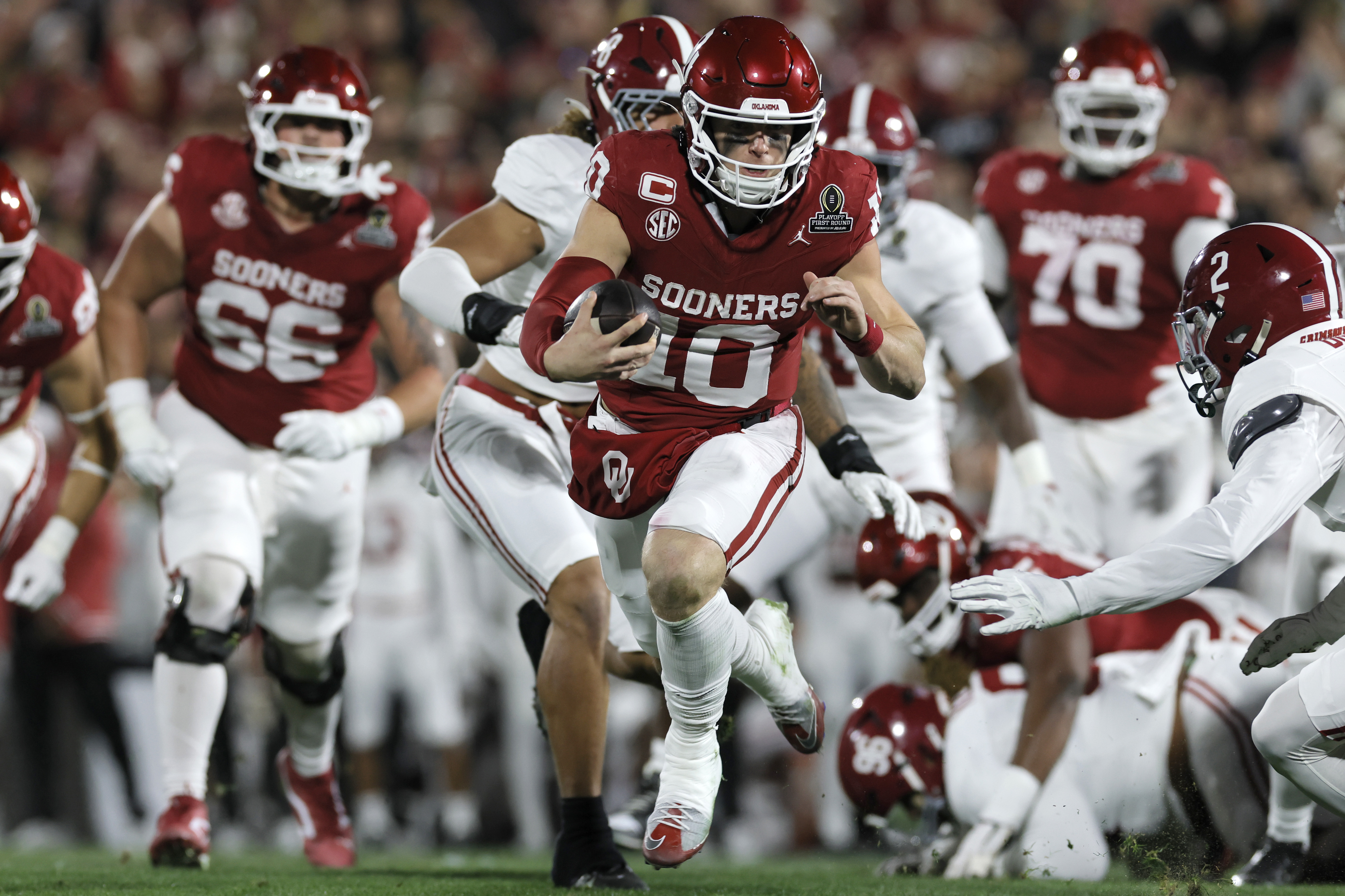 NORMAN, OKLAHOMA - DECEMBER 19: John Mateer #10 of the Oklahoma Sooners runs the ball for touchdown during the first quarter against the Alabama Crimson Tide during 2025 College Football Playoff First Round Game at Gaylord Family Oklahoma Memorial Stadium on December 19, 2025 in Norman, Oklahoma. (Photo by Brian Bahr/Getty Images)