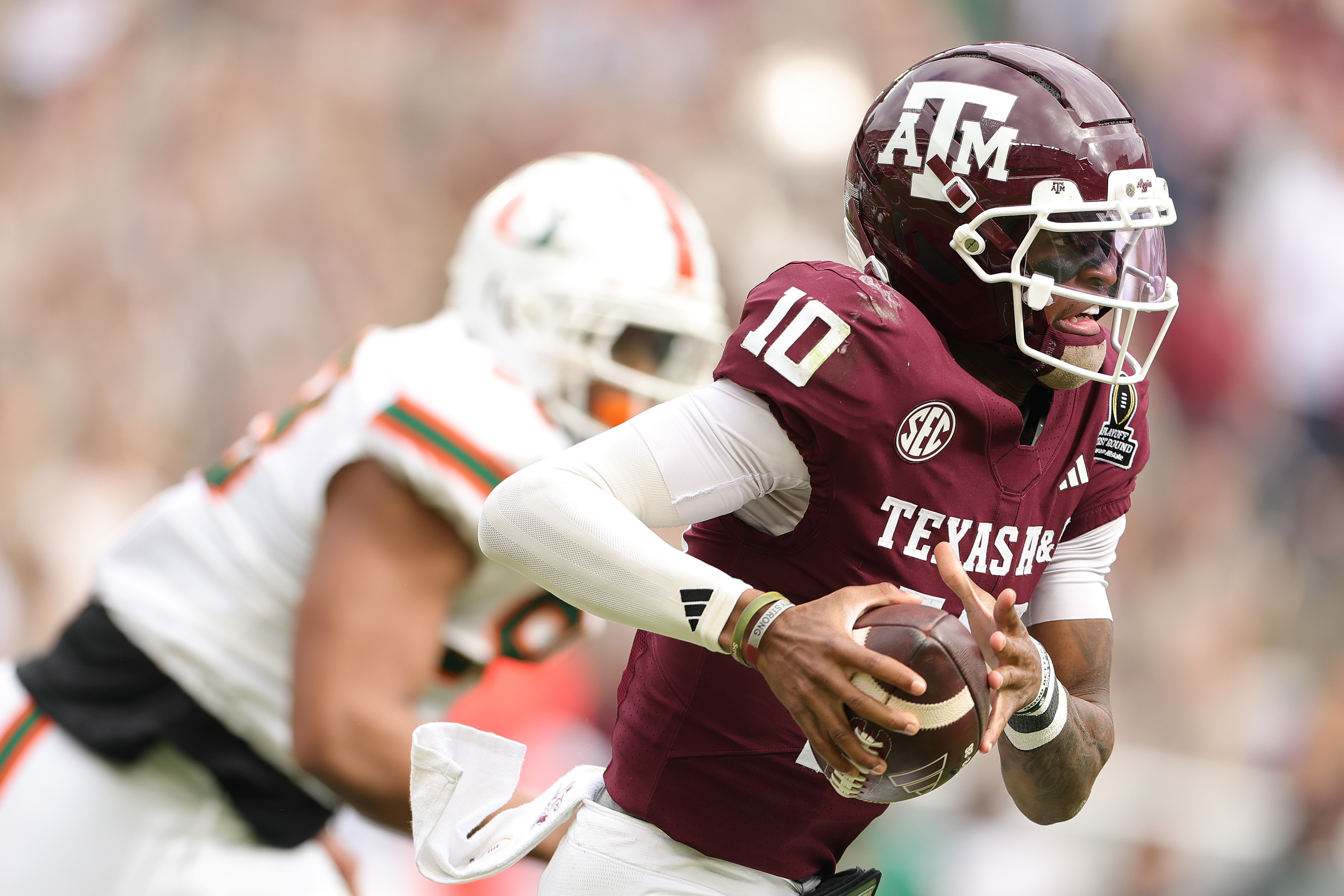 COLLEGE STATION, TEXAS - DECEMBER 20: Marcel Reed #10 of the Texas A&M Aggies runs the ball against the Miami Hurricanes during the 2025 College Football Playoff First Round Game at Kyle Field on December 20, 2025 in College Station, Texas.  (Photo by Alex Slitz/Getty Images)