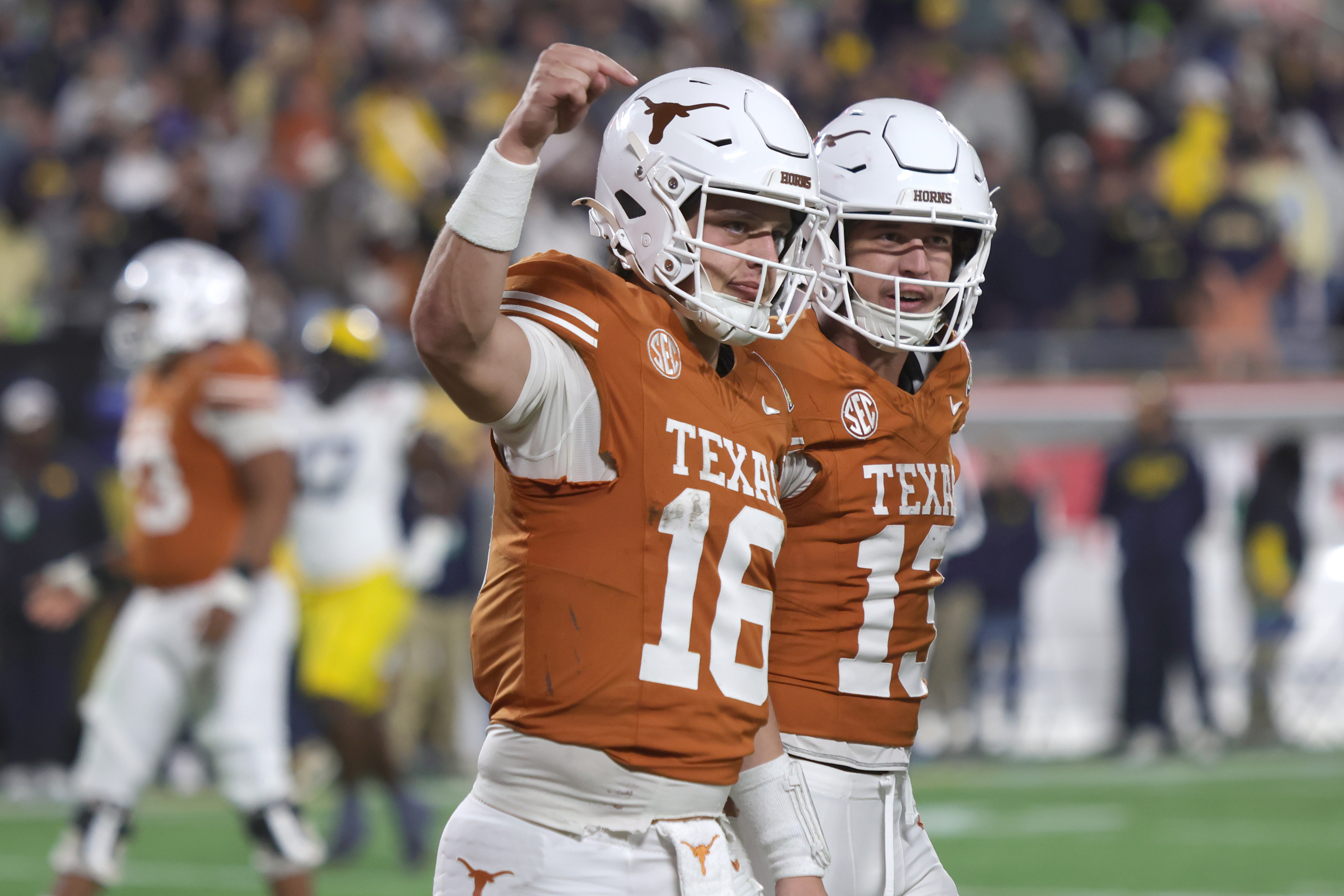 ORLANDO, FLORIDA - DECEMBER 31: Arch Manning #16 of the Texas Longhorns celebrates his 60-yard touchdown in the 4th quarter of the 2025 Cheez-It Citrus Bowl between the Texas Longhorns and Michigan Wolverines at Camping World Stadium on De…