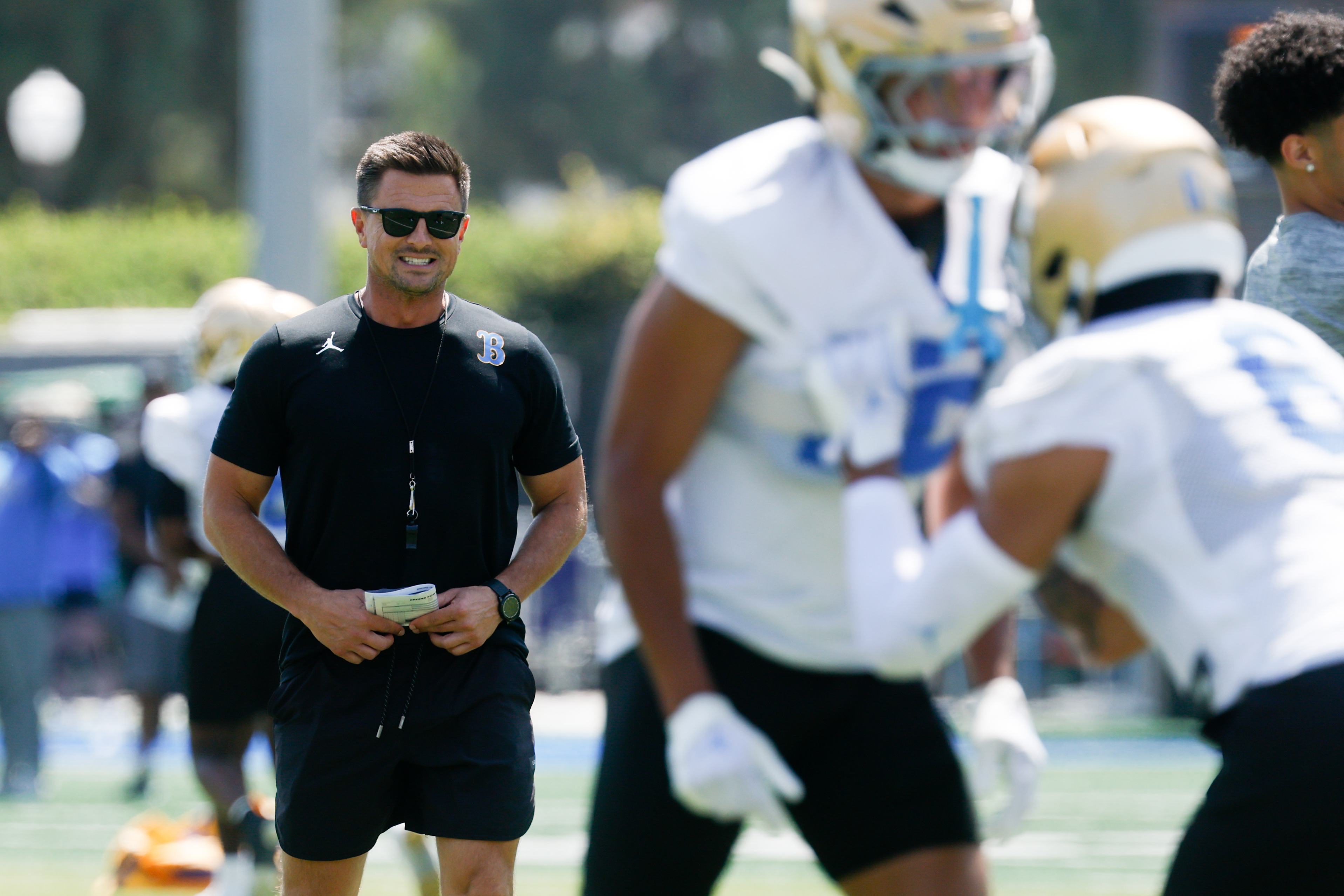 LOS ANGELES, CA - AUGUST 06, 2026: UCLA Bruins head coach Bob Chesney, left, yells to defensive players while conducting drills during UCLA preseason camp at Spalding Field at Wasserman Football Center on Thursday, Aug. 6, 2026 in Los Angeles, CA. (Ronaldo Bolanos / Los Angeles Times via Getty Images)