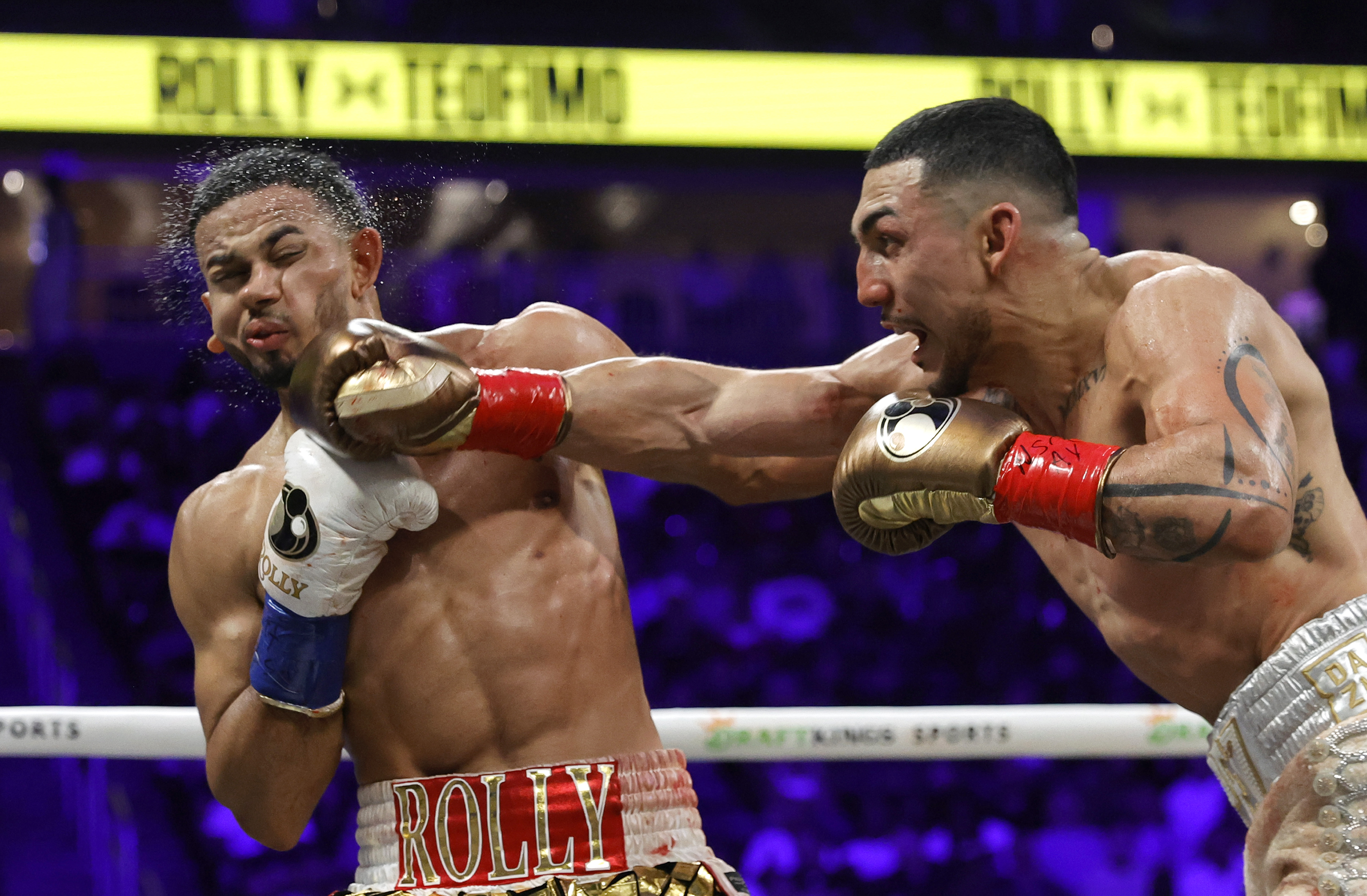 LAS VEGAS, NEVADA - AUGUST 22: Teofimo Lopez (R) connects with a punch on WBA welterweight champion Rolando Romero during their title fight at T-Mobile Arena on August 22, 2026 in Las Vegas, Nevada. Lopez took Romero's title by majority decision. (Photo by Steve Marcus/Getty Images)