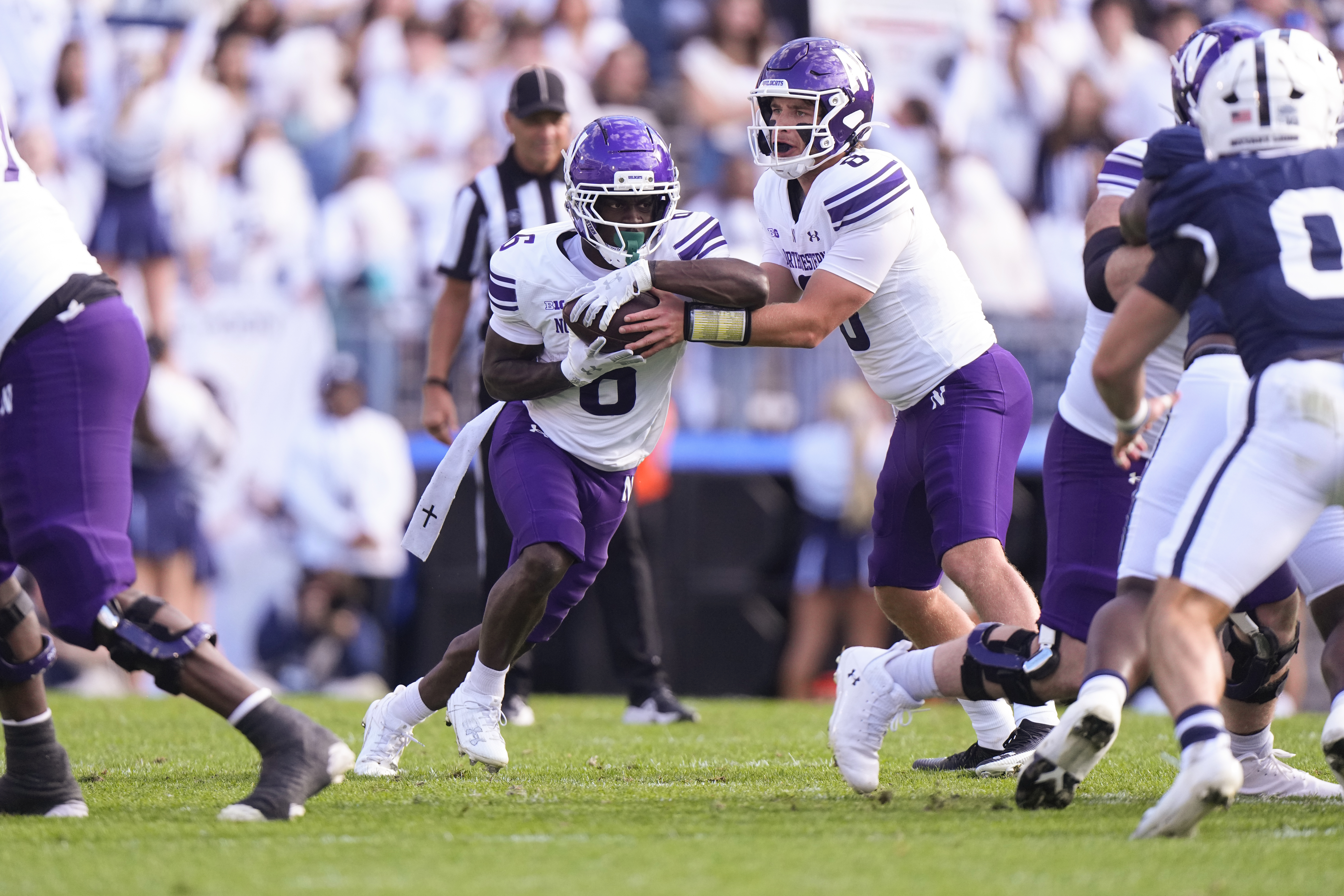 UNIVERSITY PARK, PA - OCTOBER 11: Northwestern Wildcats Quarterback Preston Stone (8) hands off the ball to Northwestern Wildcats Running Back Joseph Himon II (6) during the first half of the College Football game between the Northwestern Wildcats and the Penn State Nittany Lions on October 11, 2025, at Beaver Stadium in University Park, PA. (Photo by Gregory Fisher/Icon Sportswire via Getty Images)