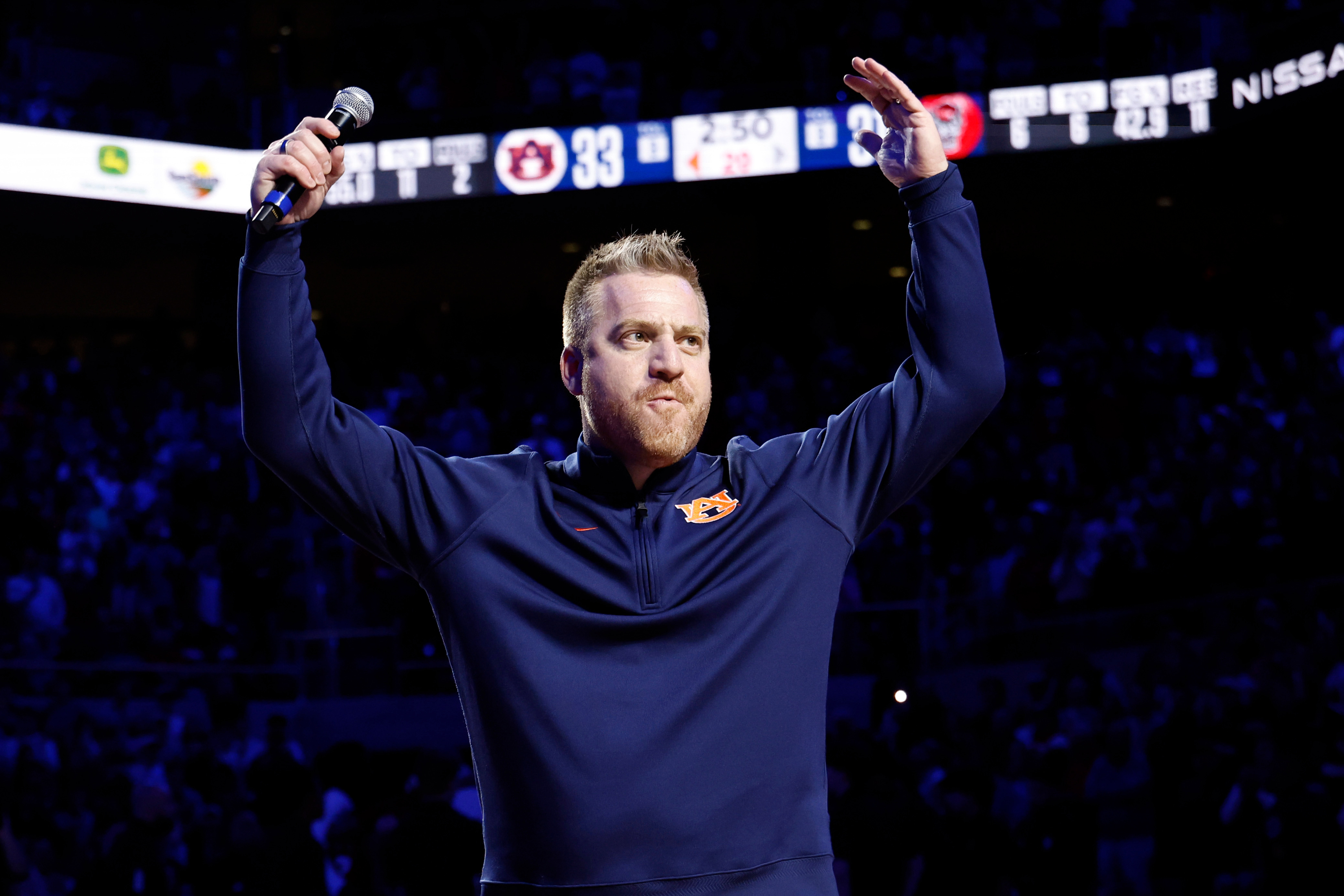Auburn new head football coach Alex Golesh is introduced during the first half of an NCAA college basketball game, Wednesday, Dec. 3, 2025, in Auburn, Ala. (AP Photo/Butch Dill)