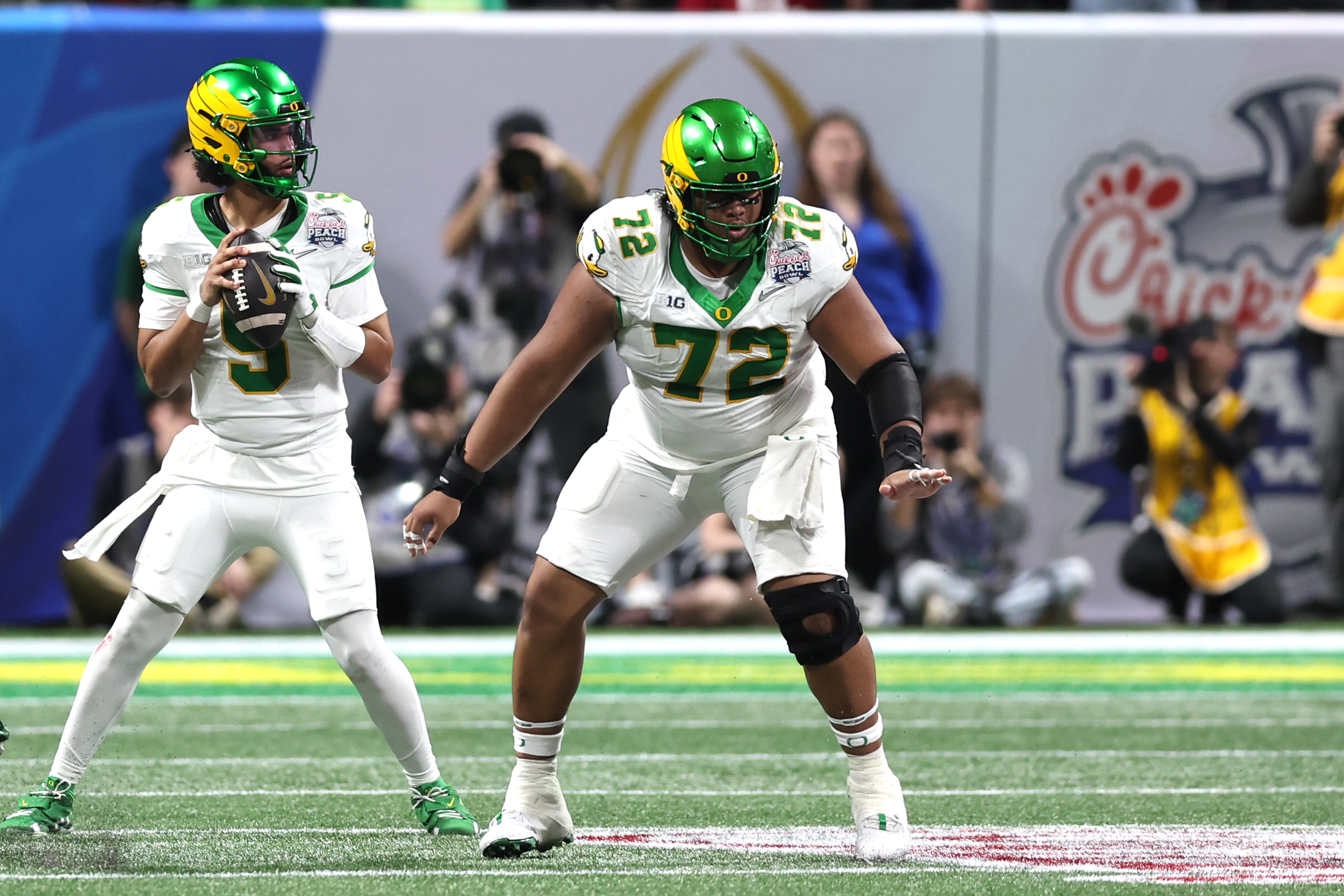 ATLANTA, GA - JANUARY 09: OL Iapani Laloulu #72 of the Oregon Ducks blocks while QB Dante Moore #5 of the Oregon Ducks attempts a pass during the Indiana Hoosiers versus Oregon Ducks College Football Playoff Semifinal at the Chick-Fil-A Peach Bowl on January 9, 2026 at Mercedes-Benz Stadium in Atlanta, GA. (Photo by Jeff Robinson/Icon Sportswire via Getty Images)