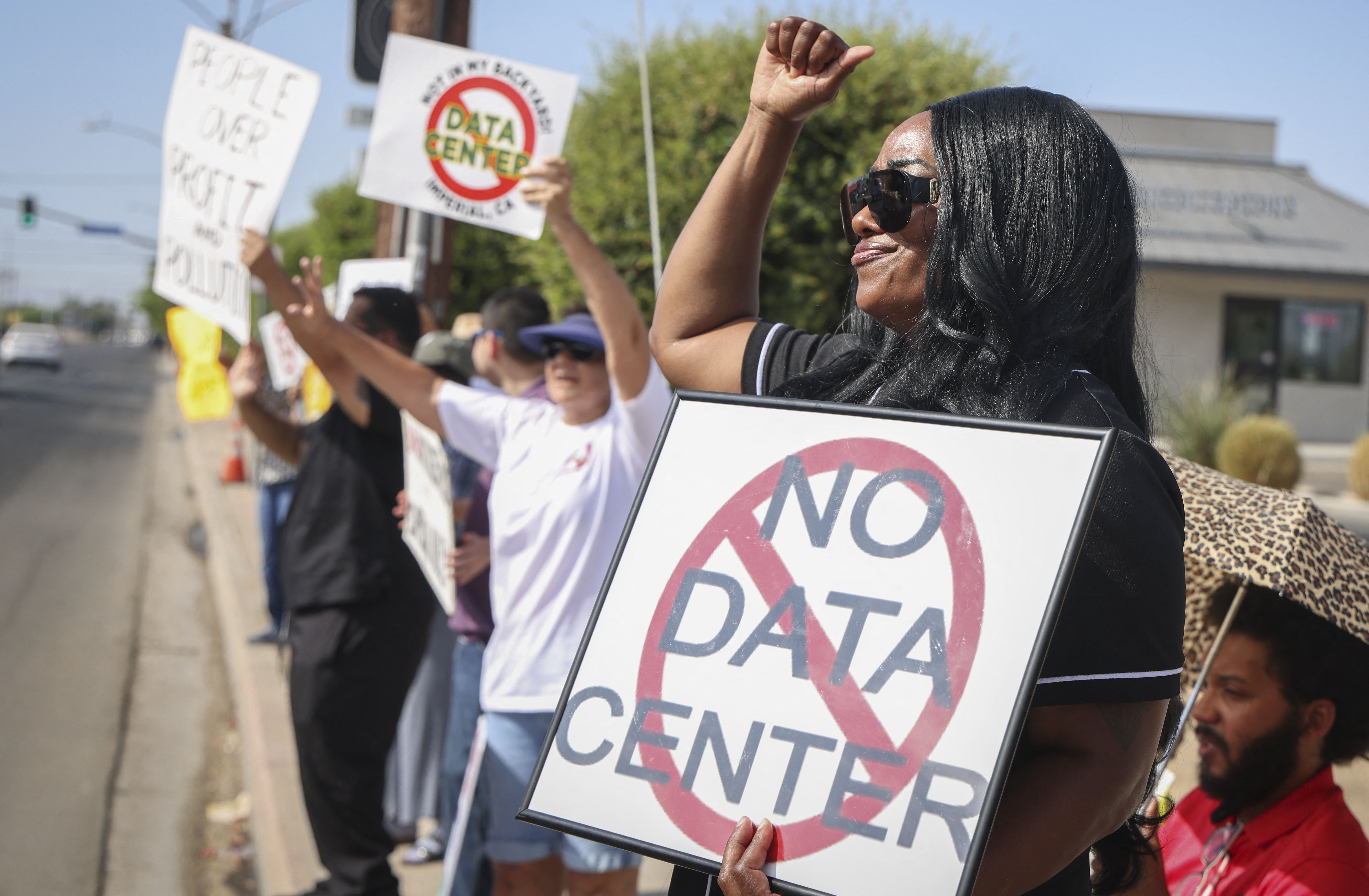 Demonstrators wave signs during a nationwide protest against AI data center expansion in Imperial, California on July 18, 2026.
