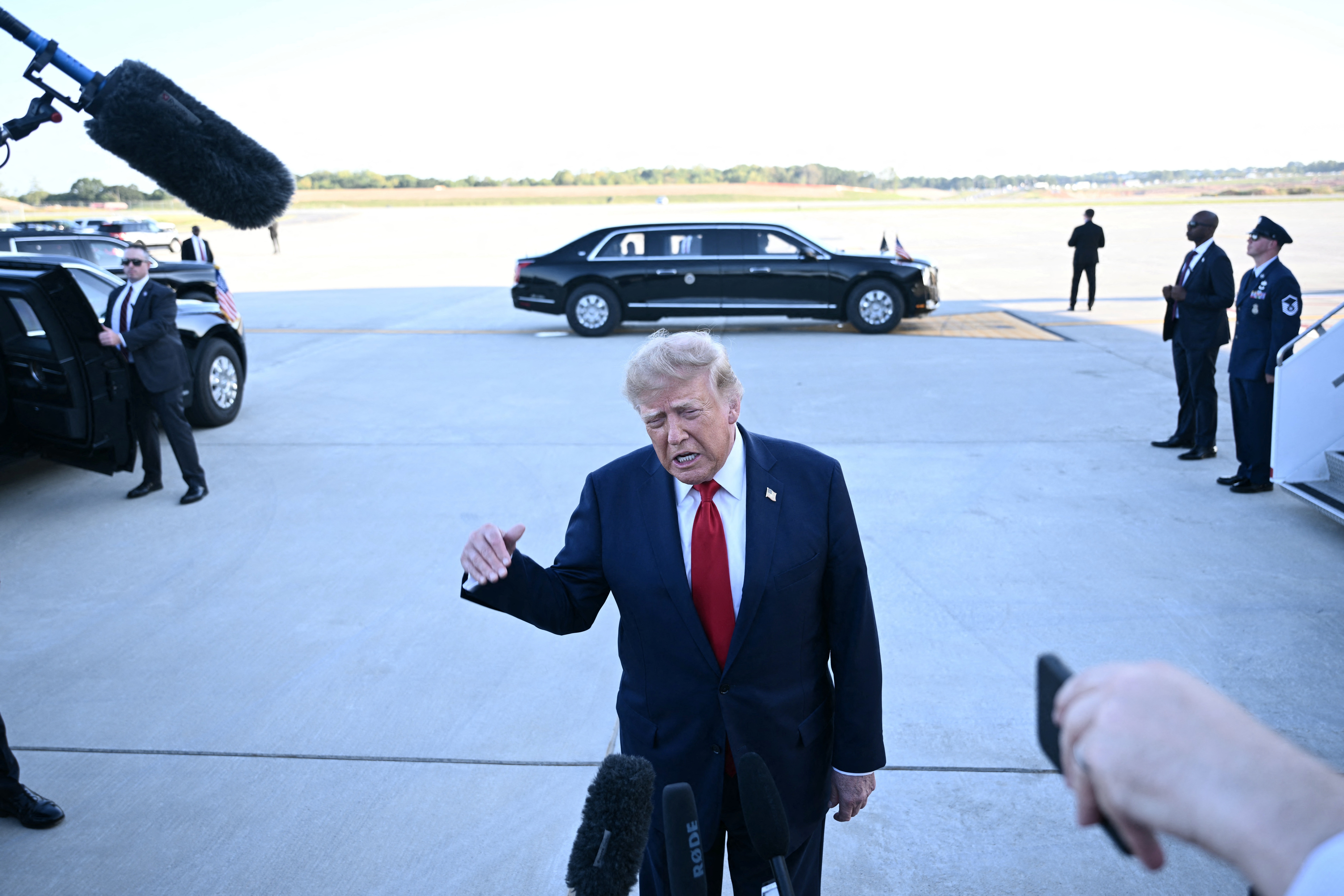 US President Donald Trump speaks to the press upon arrival at Charlotte Douglas International Airport in Charlotte, North Carolina, on September 16, 2026. Trump is campaigning for Republican US Senate candidate Michael Whatley. (Photo by Brendan SMIALOWSKI / AFP via Getty Images)