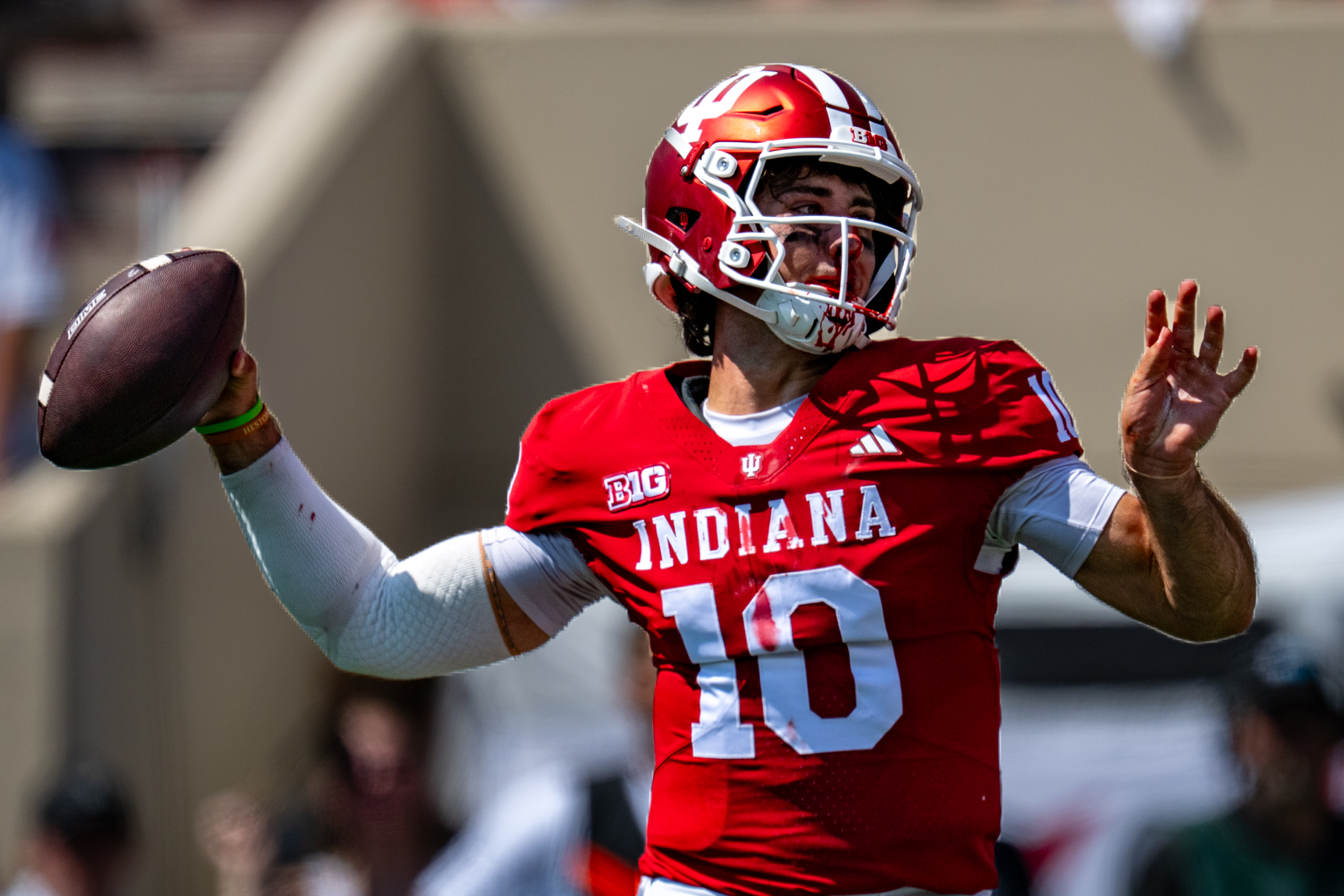 A bloodied Indiana quarterback Josh Hoover (10) looks to pass during the first half of an NCAA college football game against North Texas, Saturday, Sept. 5, 2026, in Bloomington, Ind. (AP Photo/Doug McSchooler)