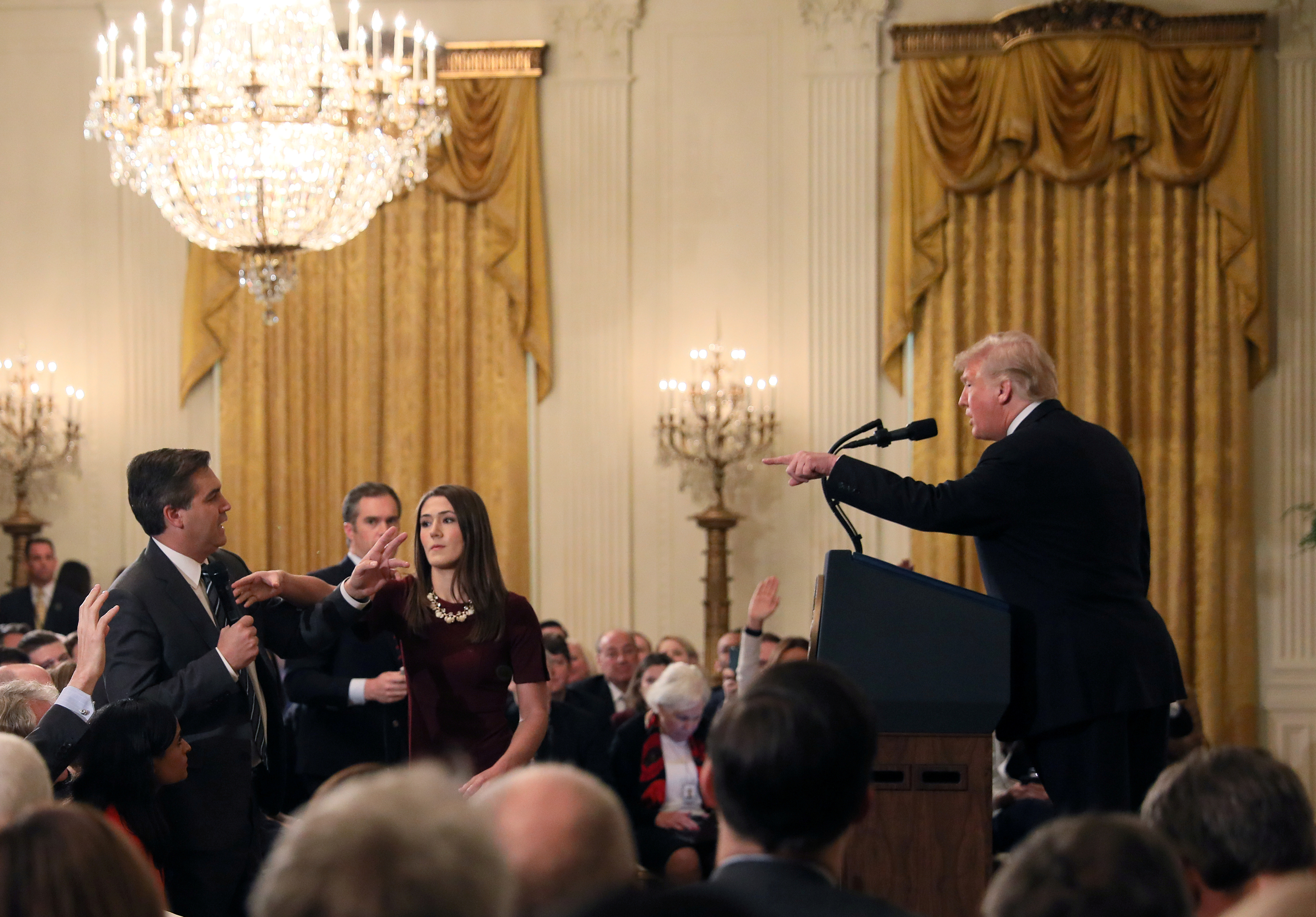 A White House staff member reaches for the microphone held by CNN's Jim Acosta as he questions President  Trump during a news conference on Nov. 7, 2018.