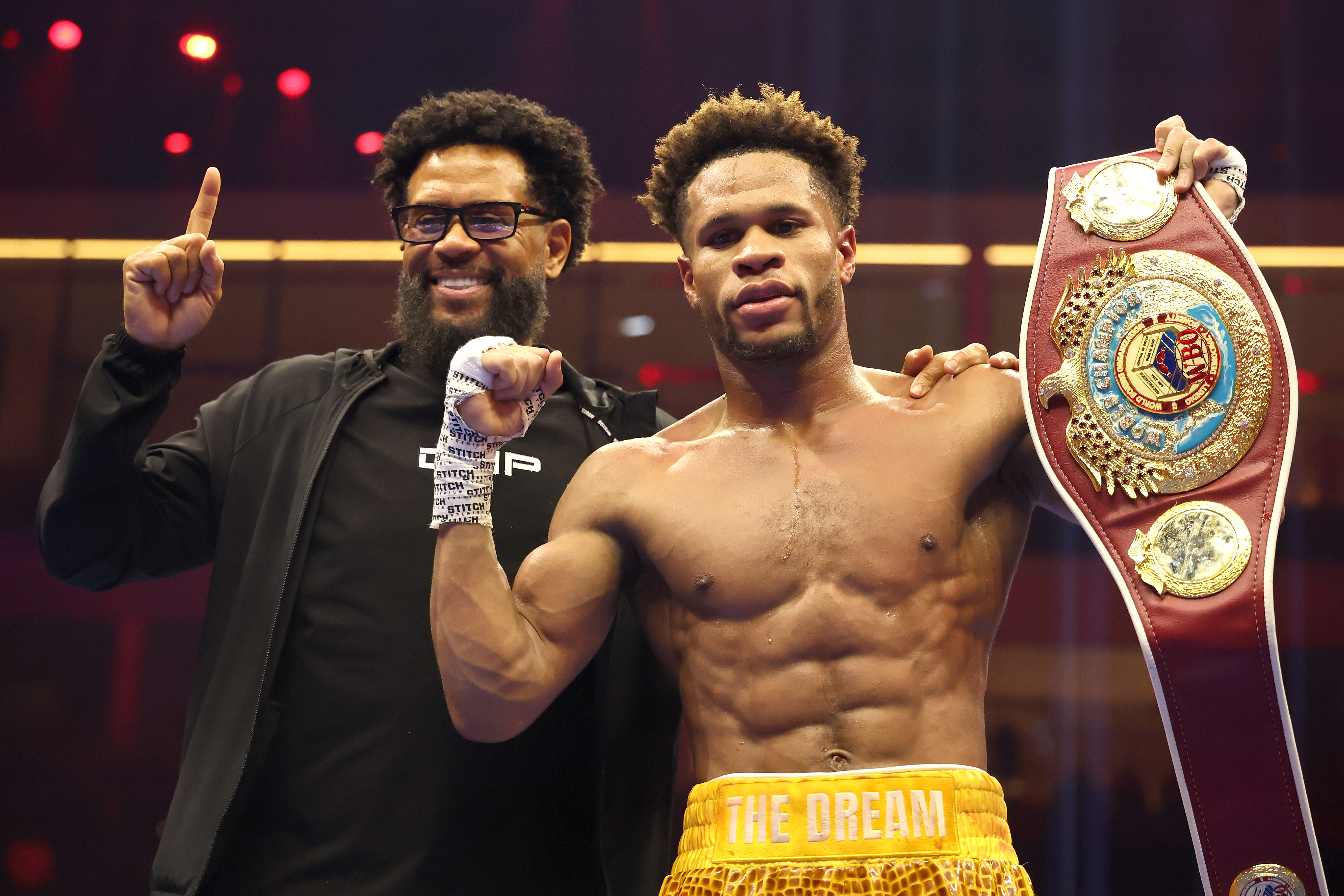 RIYADH, SAUDI ARABIA - NOVEMBER 22: Devin Haney (R) poses with his father, Bill Haney, after defeating Brian Norman Jr. by unanimous decision in a WBO world welterweight title fight during Ring IV: Night of the Champions at ANB Arena on November 22, 2025 in Riyadh, Saudi Arabia.  (Photo by Richard Pelham/Getty Images)