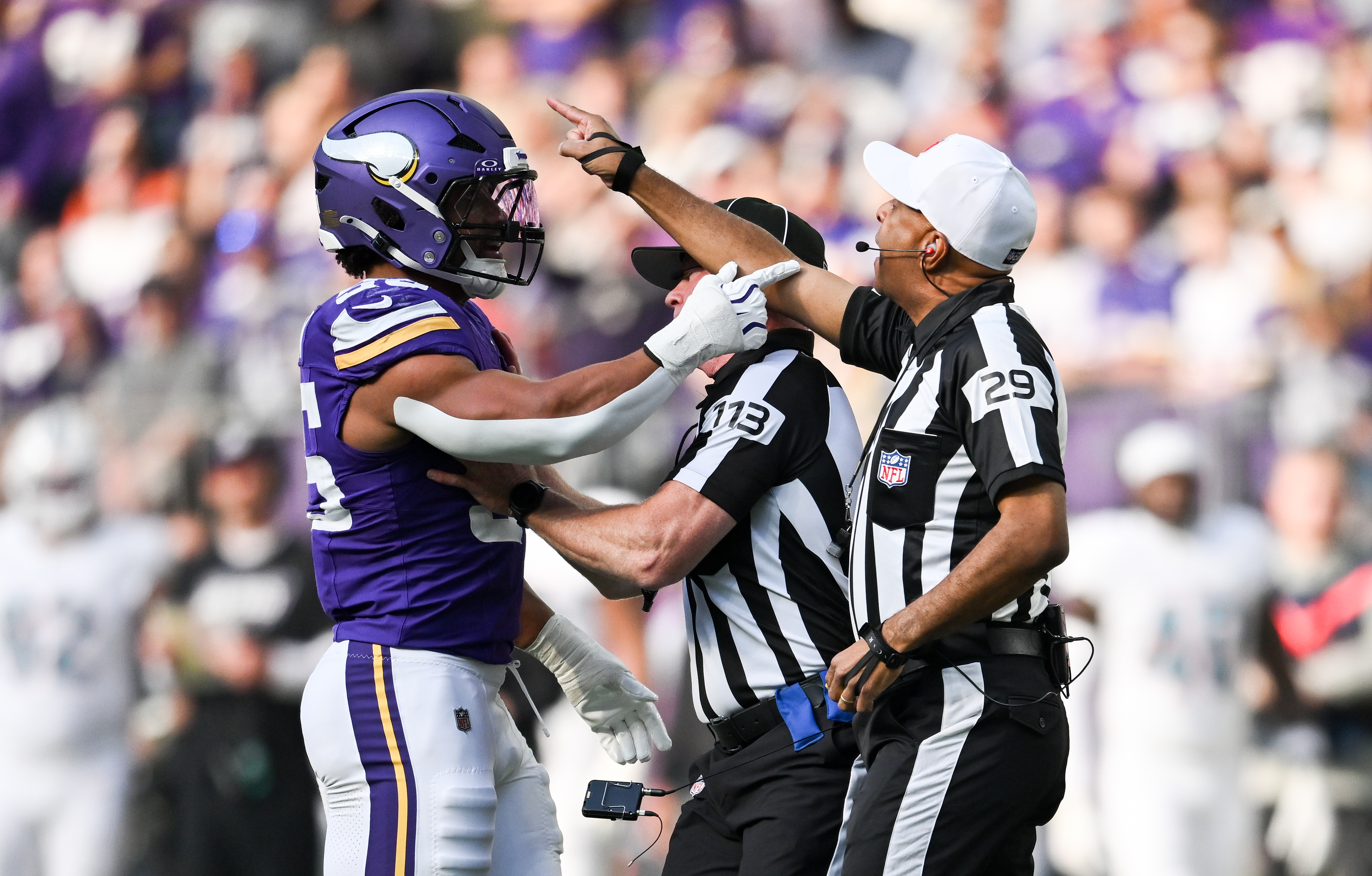 MINNEAPOLIS, MINNESOTA - OCTOBER 4: Eric Wilson #55 of the Minnesota Vikings speaks with referee Adrian Hill #29 after colliding on a play during the first quarter of the game against the Miami Dolphins at U.S. Bank Stadium on October 4, 2026 in Minneapolis, Minnesota. (Photo by Stephen Maturen/Getty Images)