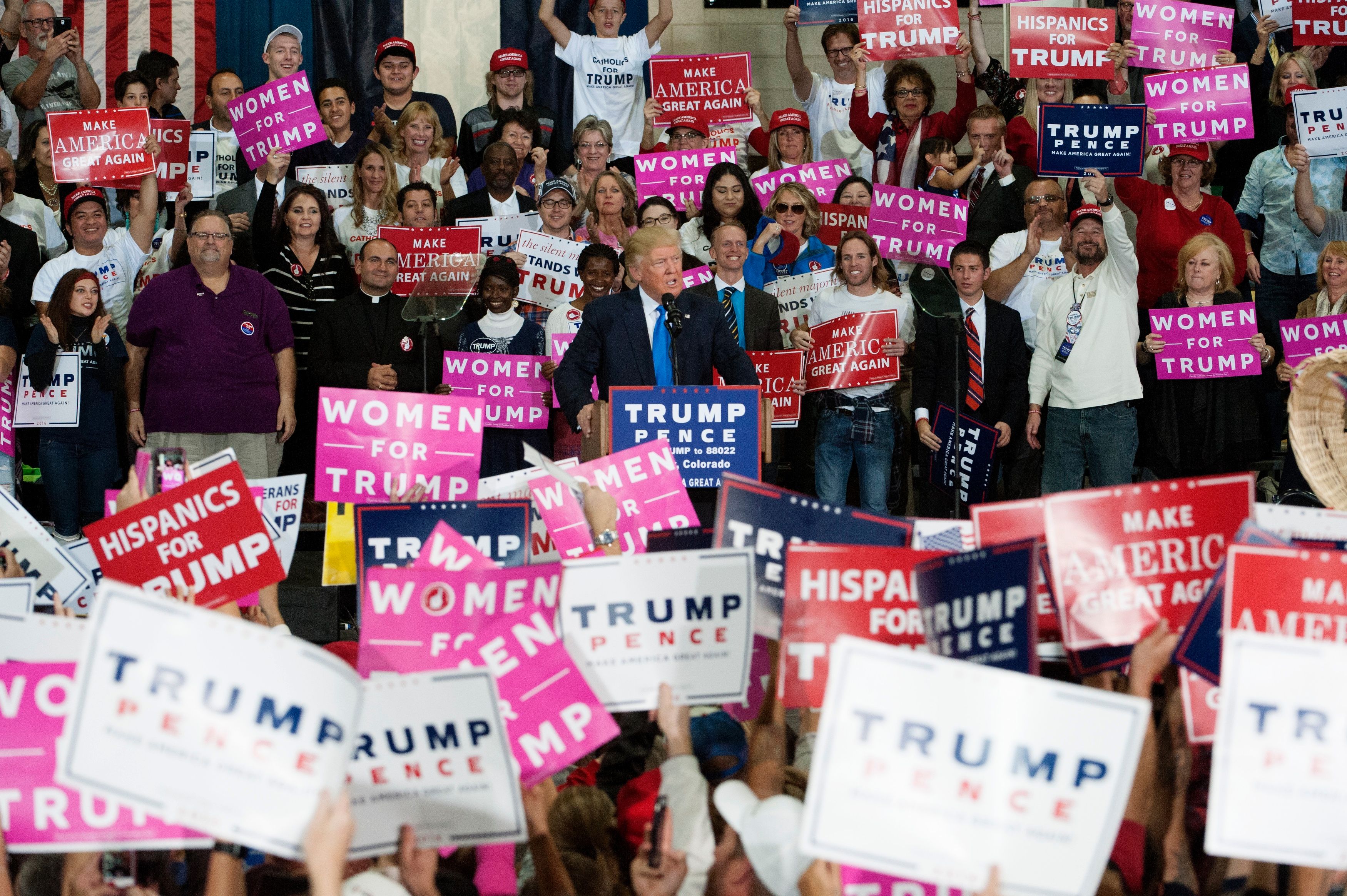 Republican presidential nominee Donald Trump (C) addresses supporters during a campaign rally at the National Western Complex in Denver, Colorado on November 5, 2016.  White House Republican candidate Donald Trump was earlier in the day bundled off stage by security officers on November 5 after a false gun scare during a campaign appearance.    / AFP / Jason Connolly        (Photo credit should read JASON CONNOLLY/AFP via Getty Images)