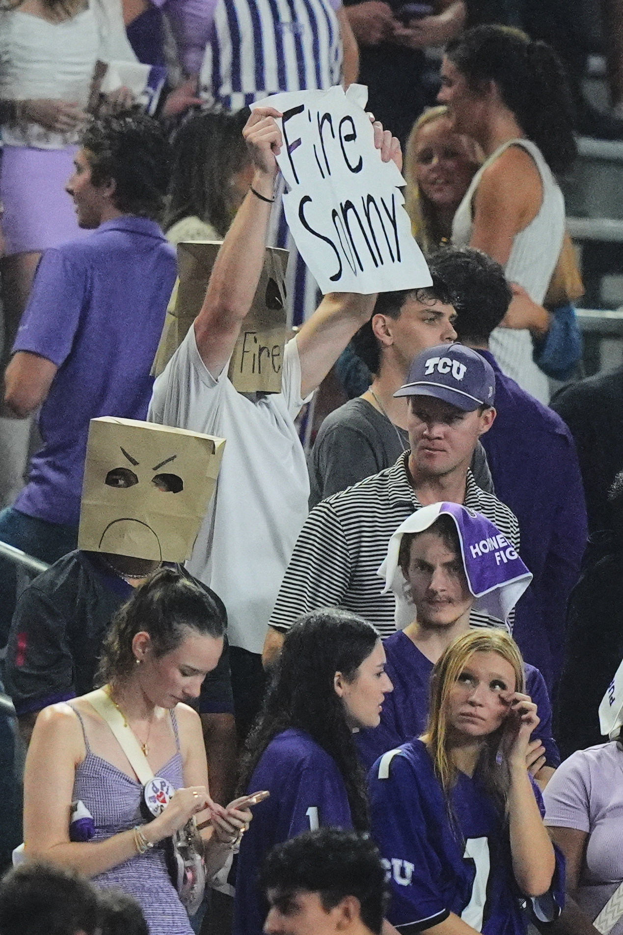 TCU fans in the stands react during the second half of an NCAA college football game against BYU, Saturday, Oct. 3, 2026, in Fort Worth, Texas. (AP Photo/LM Otero)