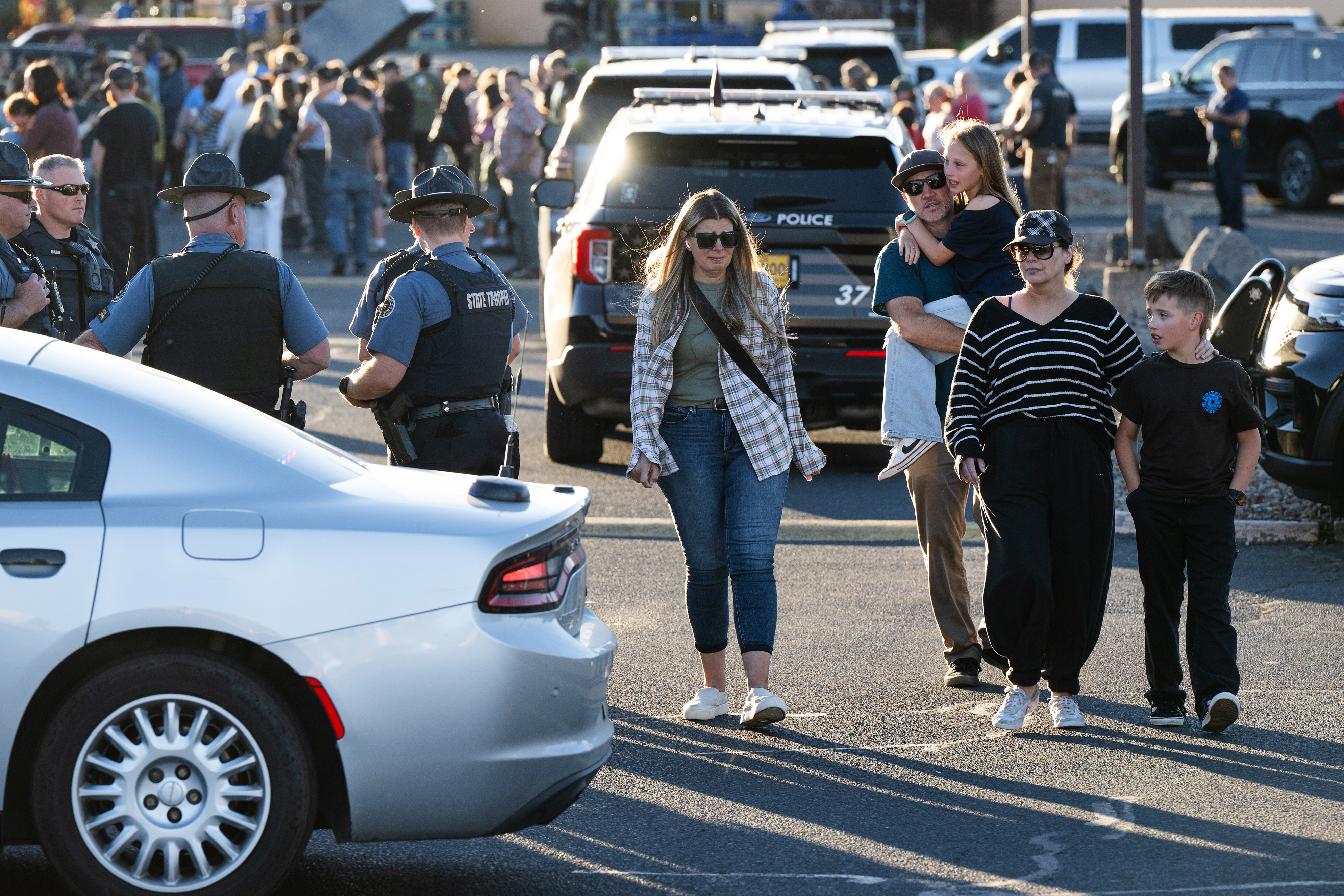 People leave a family reunification area following a shooting at Silver Rail Elementary School in Bend, Ore., on Thursday.