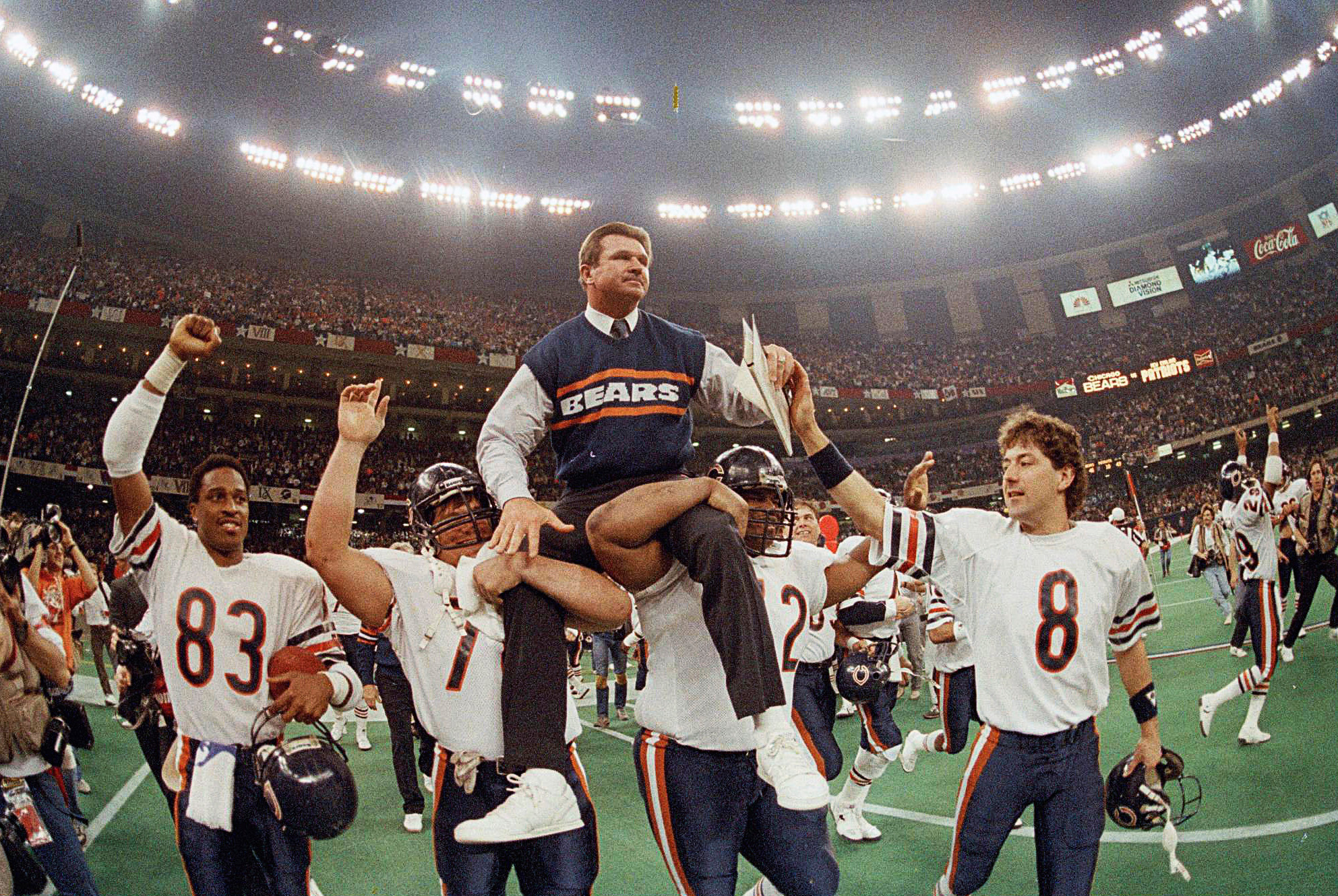 FILE - In this Jan. 26, 1986, file photo, Chicago Bears coach Mike Ditka is carried off the field by Steve McMichael, left, and William Perry after the Bears defeated the New England Patriots 46-10 in NFL football's Super Bowl XX in New Orleans. Willie Gault (83) and Maury Buford (8) join the celebration. (AP Photo/Phil Sandlin, File)
