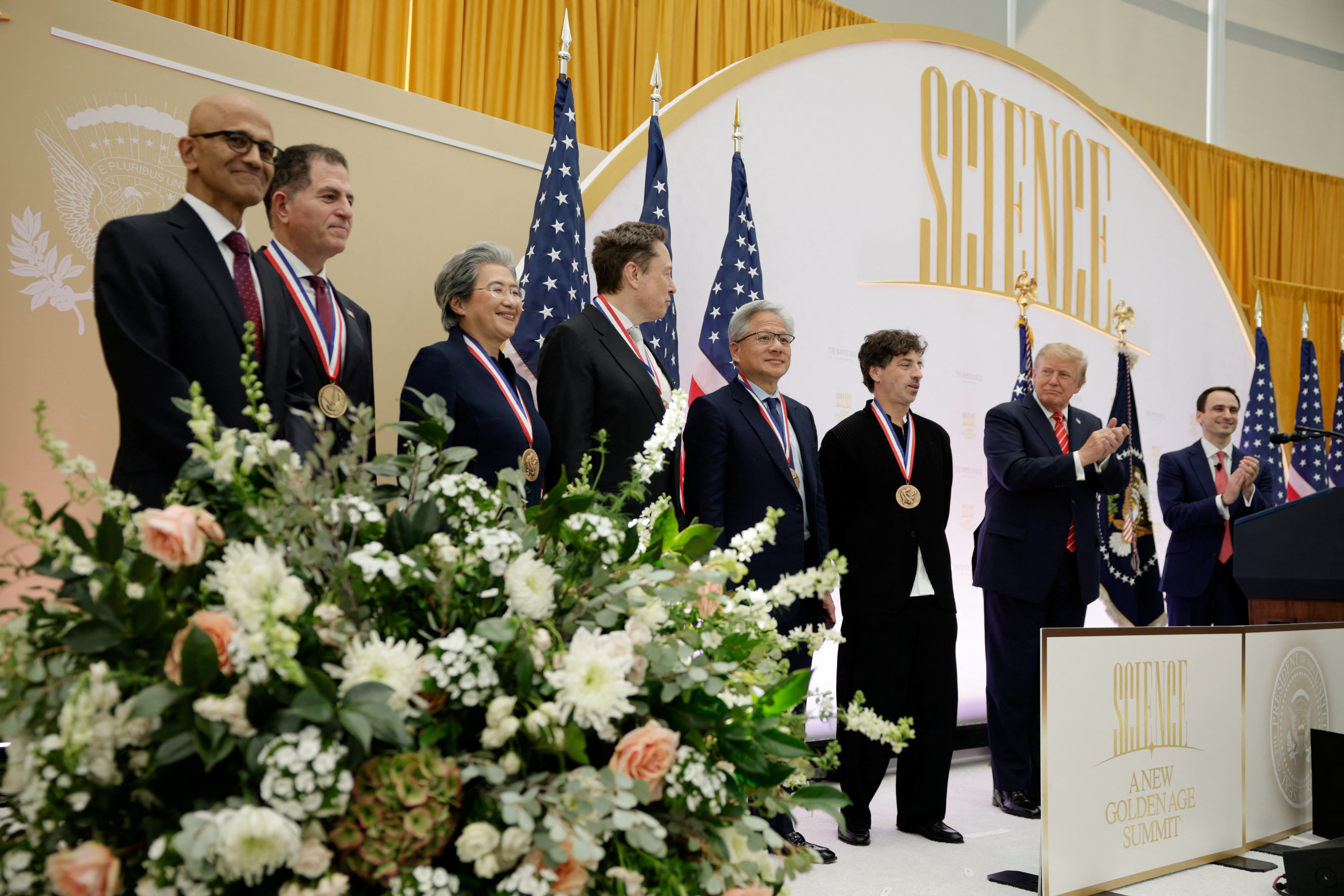 CEO of Microsoft Satya Nadella, Dell Technologies CEO Michael Dell, AMD CEO Lisa Su, Tesla and SpaceX CEO Elon Musk, NVIDIA CEO Jensen Huang, and Google co-founder Sergey Brin stand with U.S. President Donald Trump during the "A New Golden Age" summit at the US Institute of Peace, renamed The Donald J. Trump Institute of Peace by the Trump administration, in Washington, DC, US, October 8, 2026. REUTERS/Evan Vucci