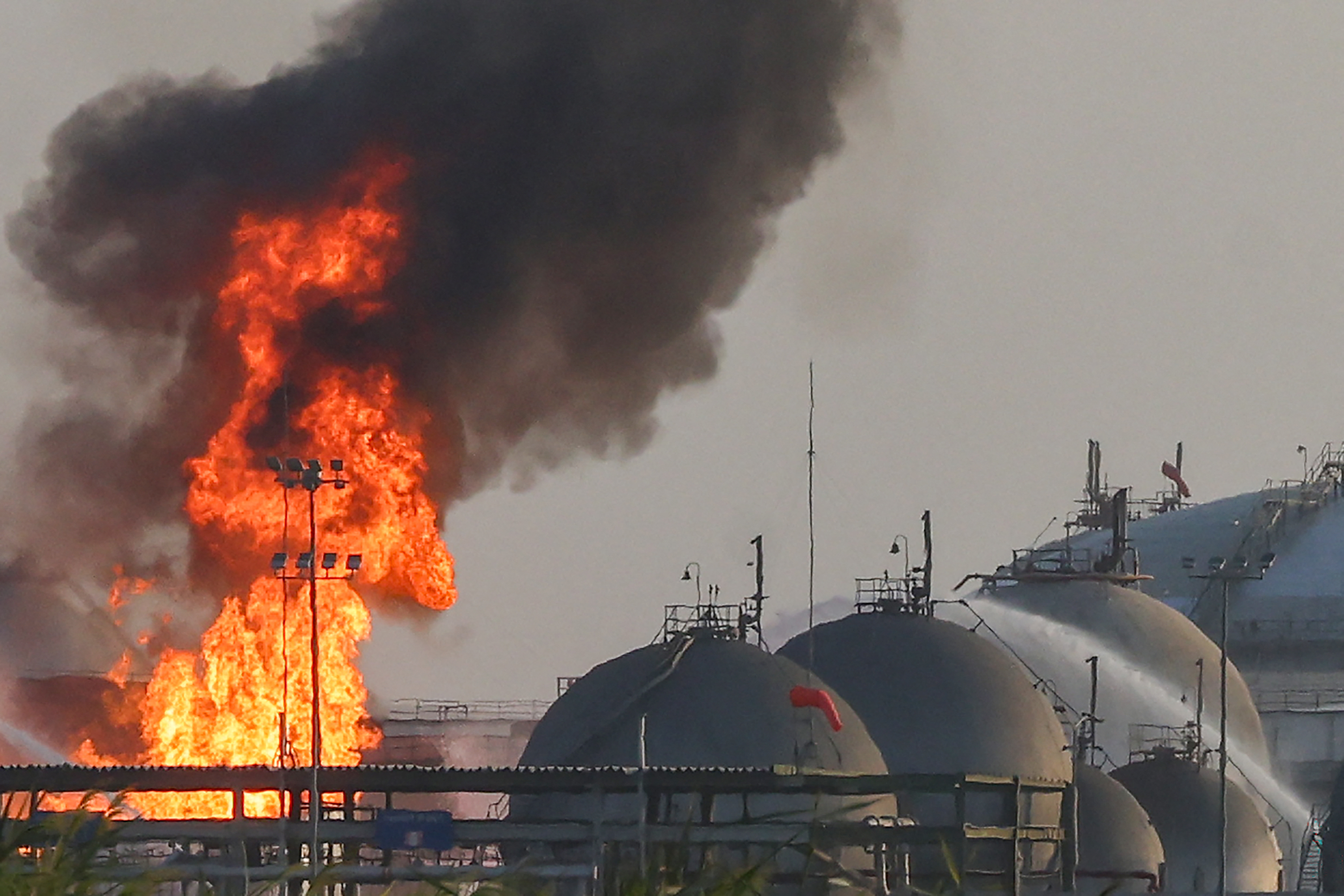 TOPSHOT - Flames burn at a facility belonging to Saudi oil giant Aramco south of Riyadh on October 3, 2026. The circumstances remained unclear but in recent weeks Aramco, majority-owned by the Saudi state, has come under attack from the Houthi authorities targeting the kingdom as part of the war in Yemen where Riyadh is backing the internationally recognised government. An AFP journalist reported seeing fire engines attempting to extinguish a blaze at the energy giant's Riyadh refinery, located south of the capital, while ambulances and police vehicles were stationed near the facility. (Photo by AFP via Getty Images) / 