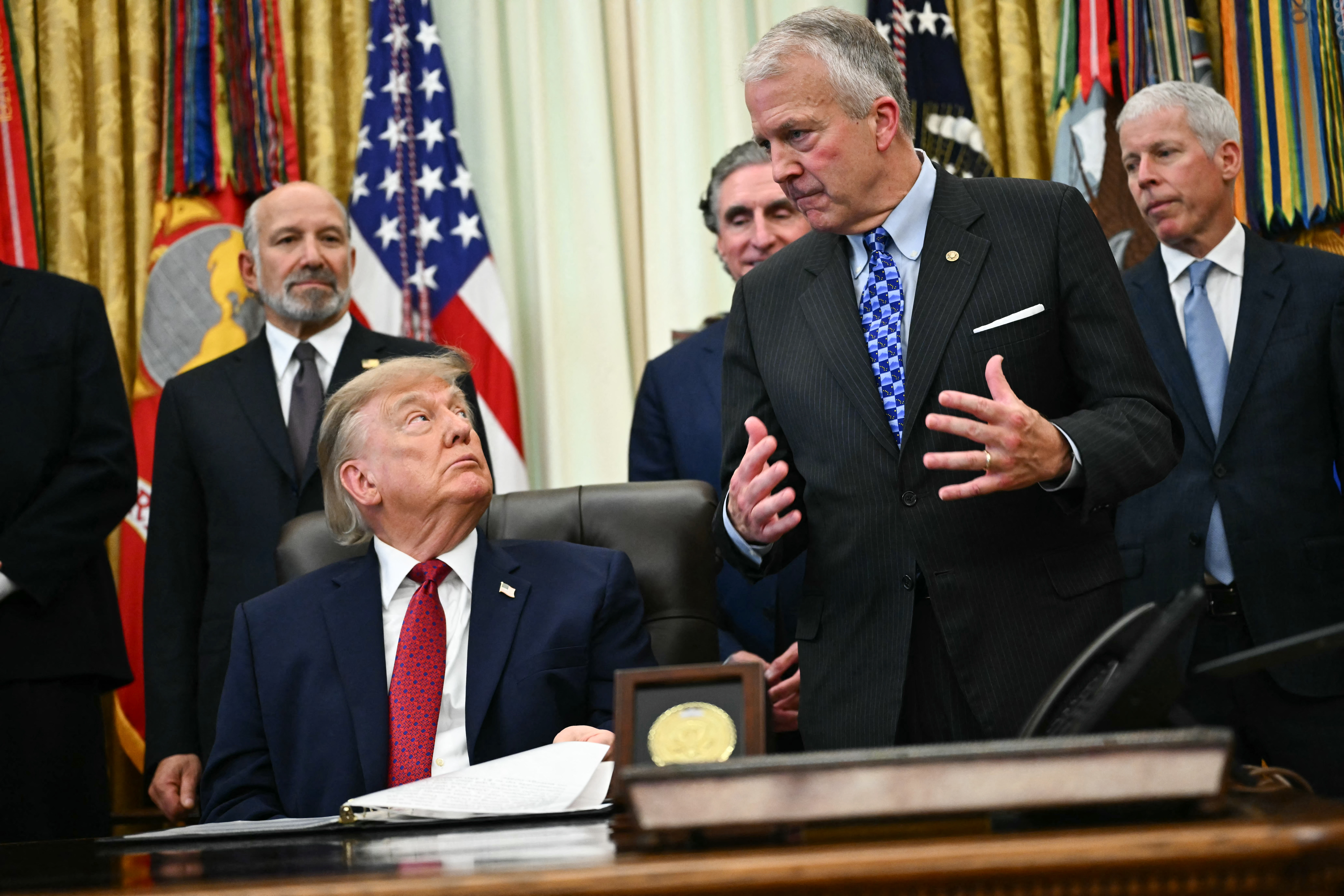 US President Donald Trump listens to US Senator Dan  Sullivan, Republican from Alaska, as he makes an announcement with US Secretary of Commerce Howard Lutnick (L) in the Oval Office of the White House in Washington, DC, on September 30, 2026. (Photo by Kent NISHIMURA / AFP via Getty Images)