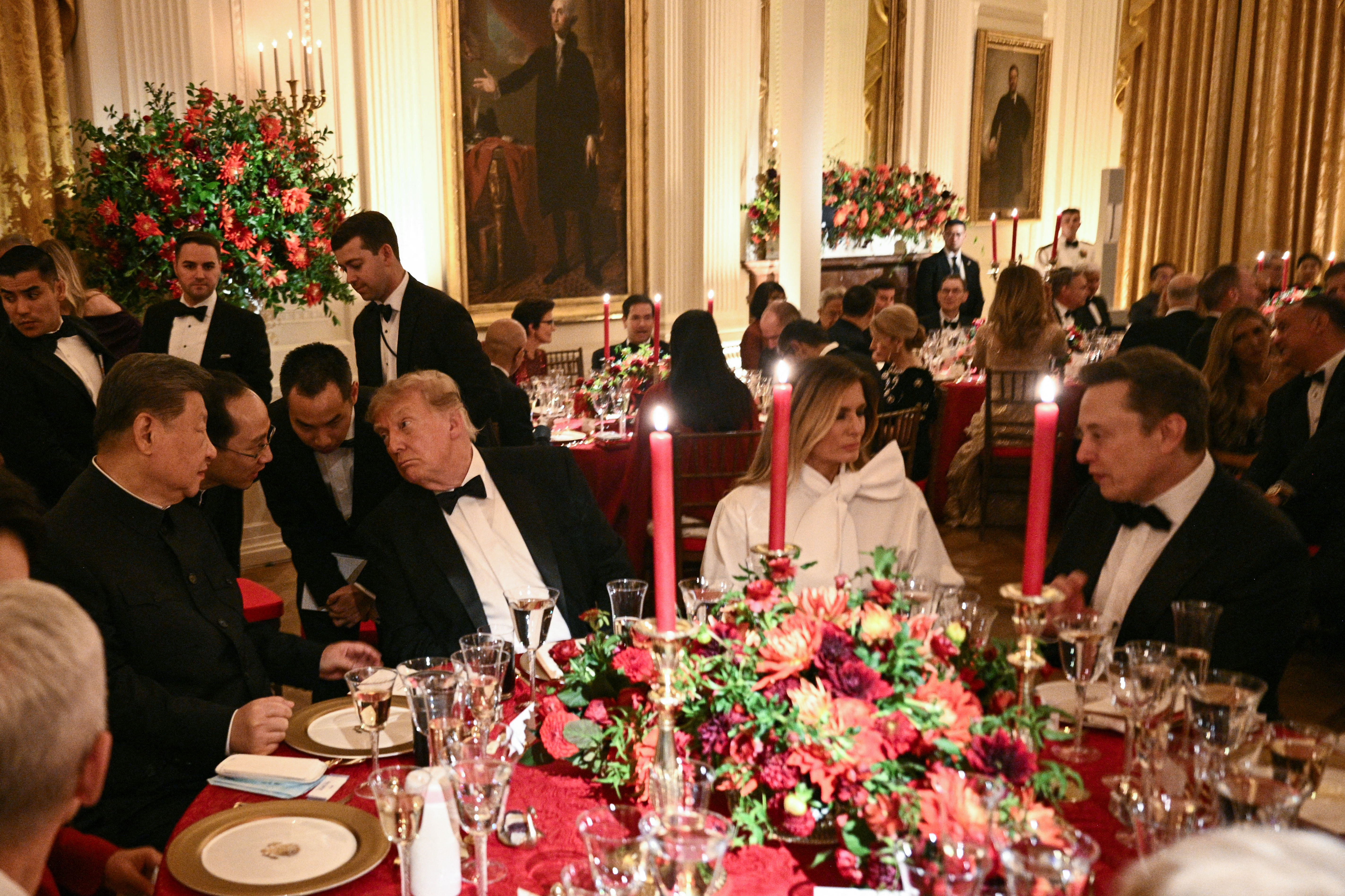 TOPSHOT - China's President Xi Jinping (L) and US President Donald Trump speak through interpreters as First Lady Melania Trump listens to Tesla CEO Elon Musk during a State Dinner in the East Room of the White House in Washington, DC, on September 24, 2026. President Xi is on a State visit to the United States from September 23 to 25. (Photo by Brendan SMIALOWSKI / AFP via Getty Images)