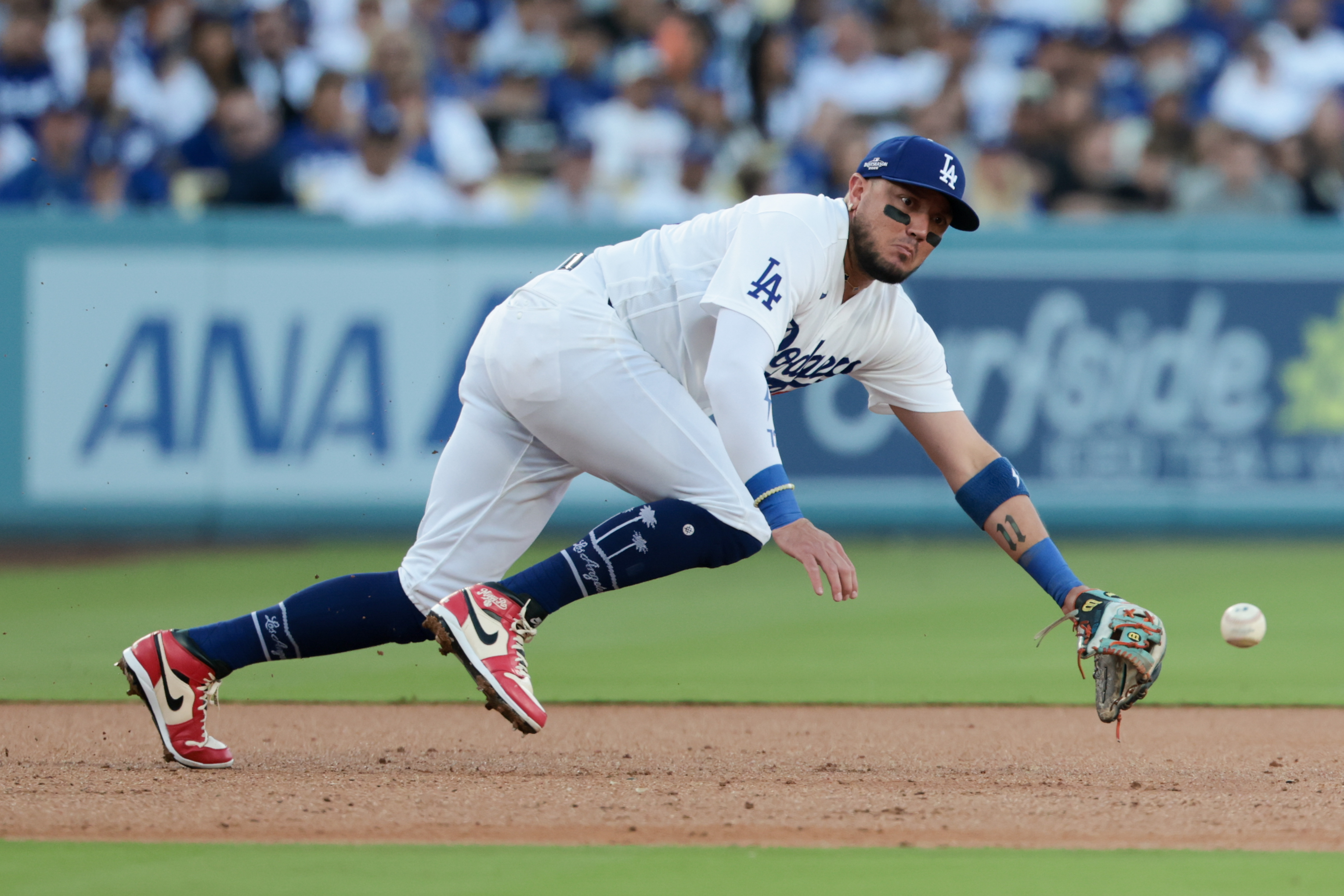 LOS ANGELES, CALIFORNIA - OCTOBER 14: Los Angeles Dodgers second baseman Miguel Rojas (72) is unable to make a play on a ground ball during the second inning in game three of NLDS between the Los Angeles Dodgers and the Milwaukee Brewers at Dodger Stadium on Wednesday, Oct. 14, 2026 in Los Angeles, California. (Robert Gauthier / Los Angeles Times via Getty Images)
