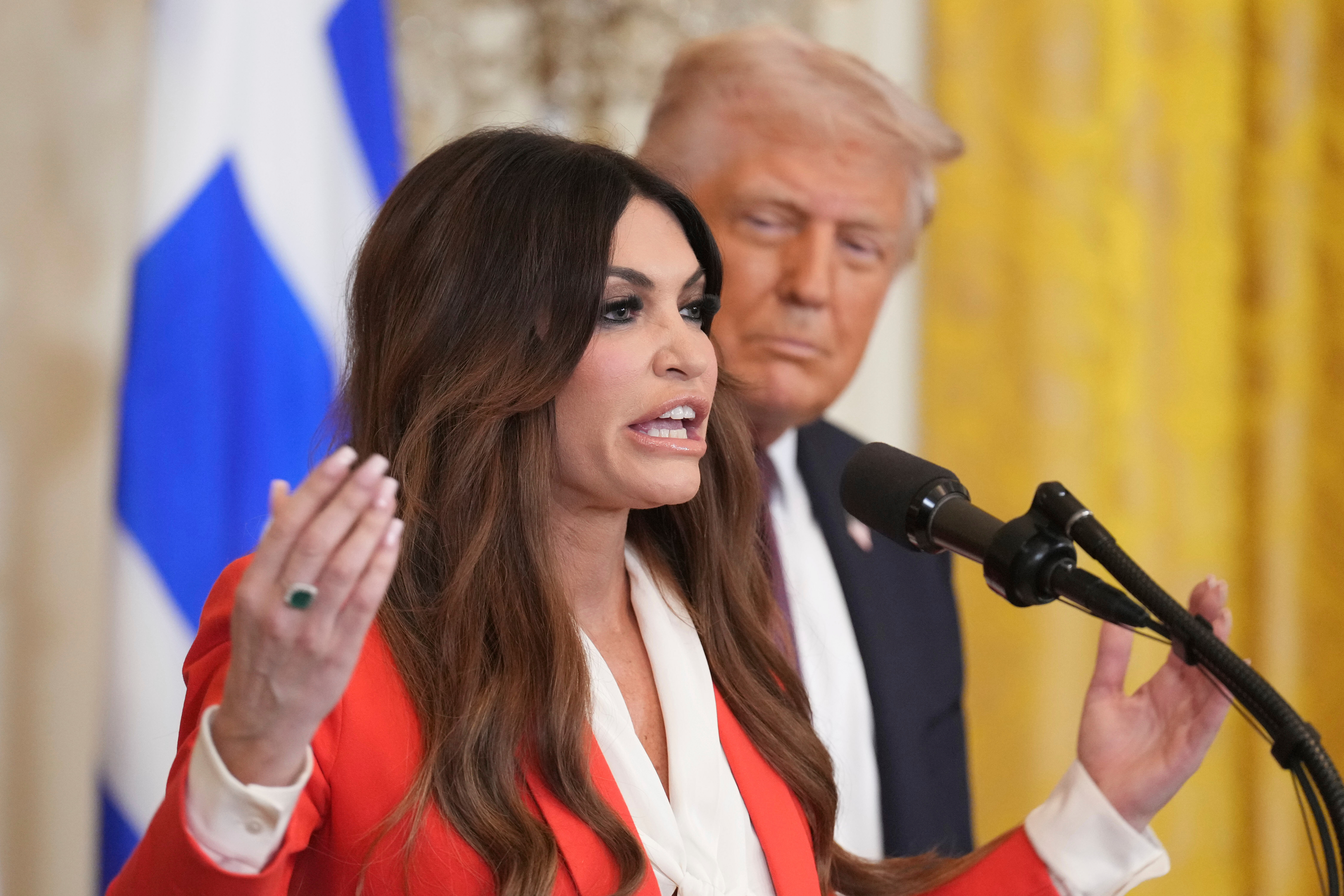 Kimberly Guilfoyle speaks as President Trump listens at a Greek Independence Day reception at the White House in 2025.