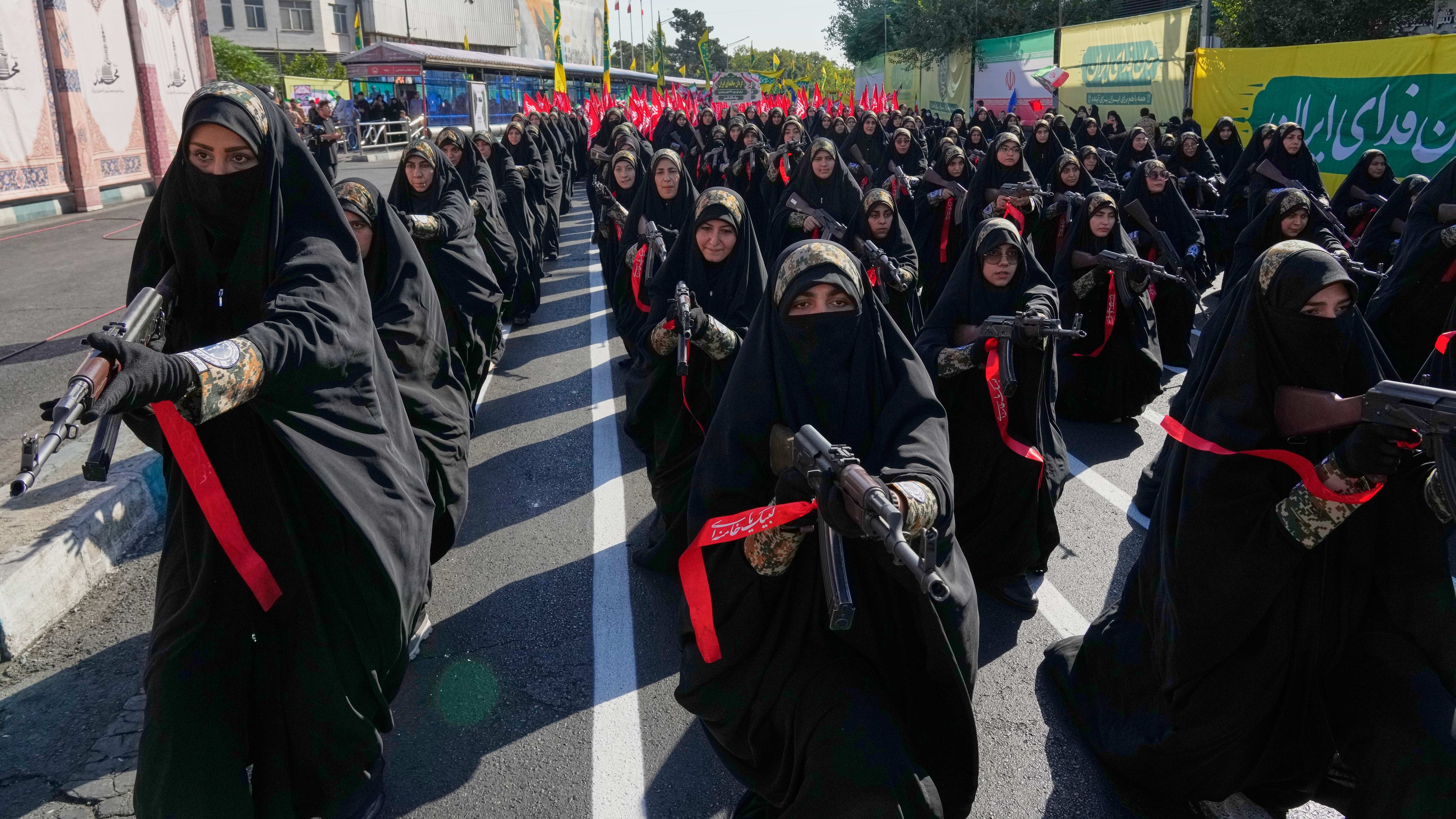 Crowds of people gathered in a large public square in Iran for a rally.
