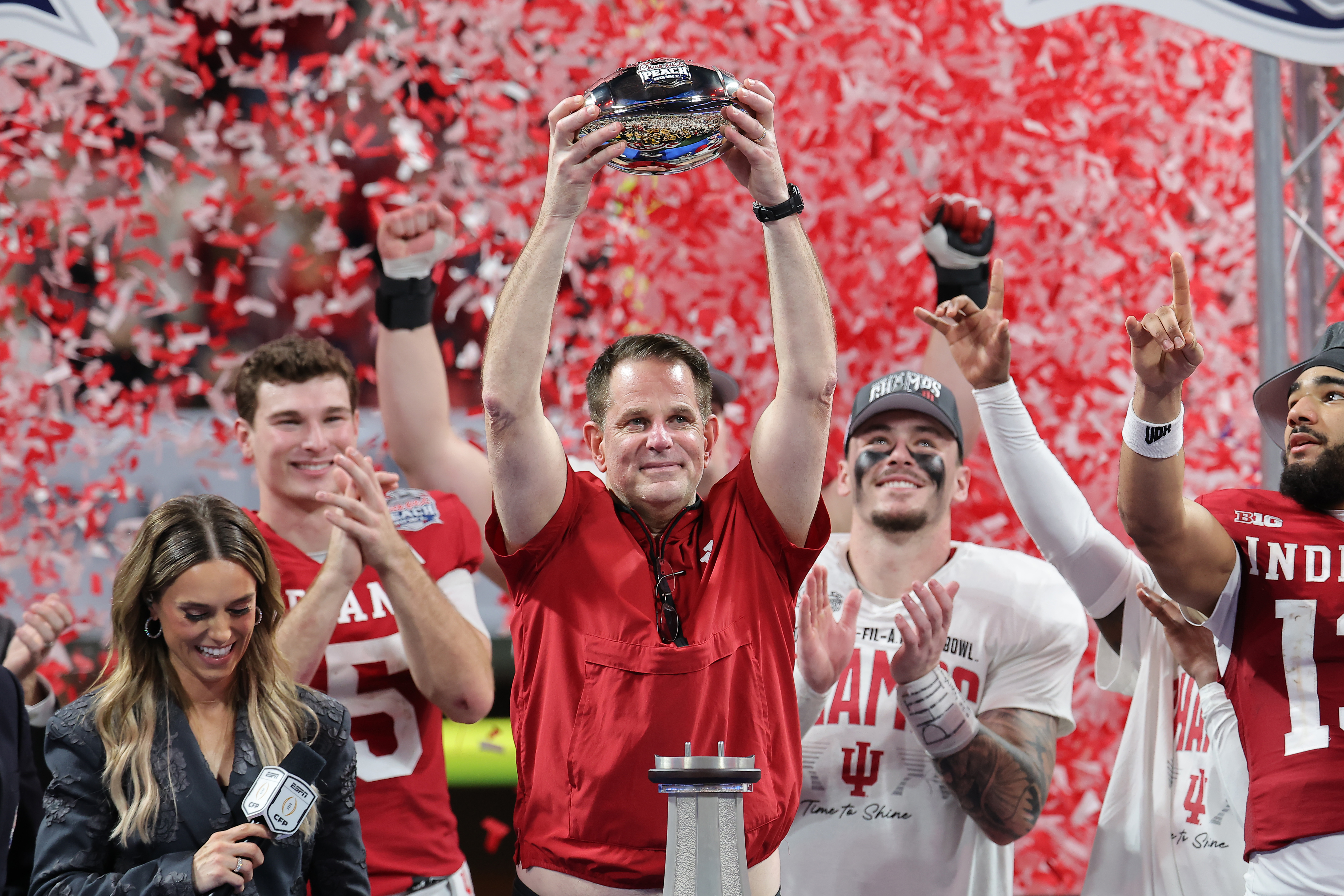 Indiana coach Curt Cignetti hoists the trophy after winning the Peach Bowl. (Jonathan Bachman/Getty Images)