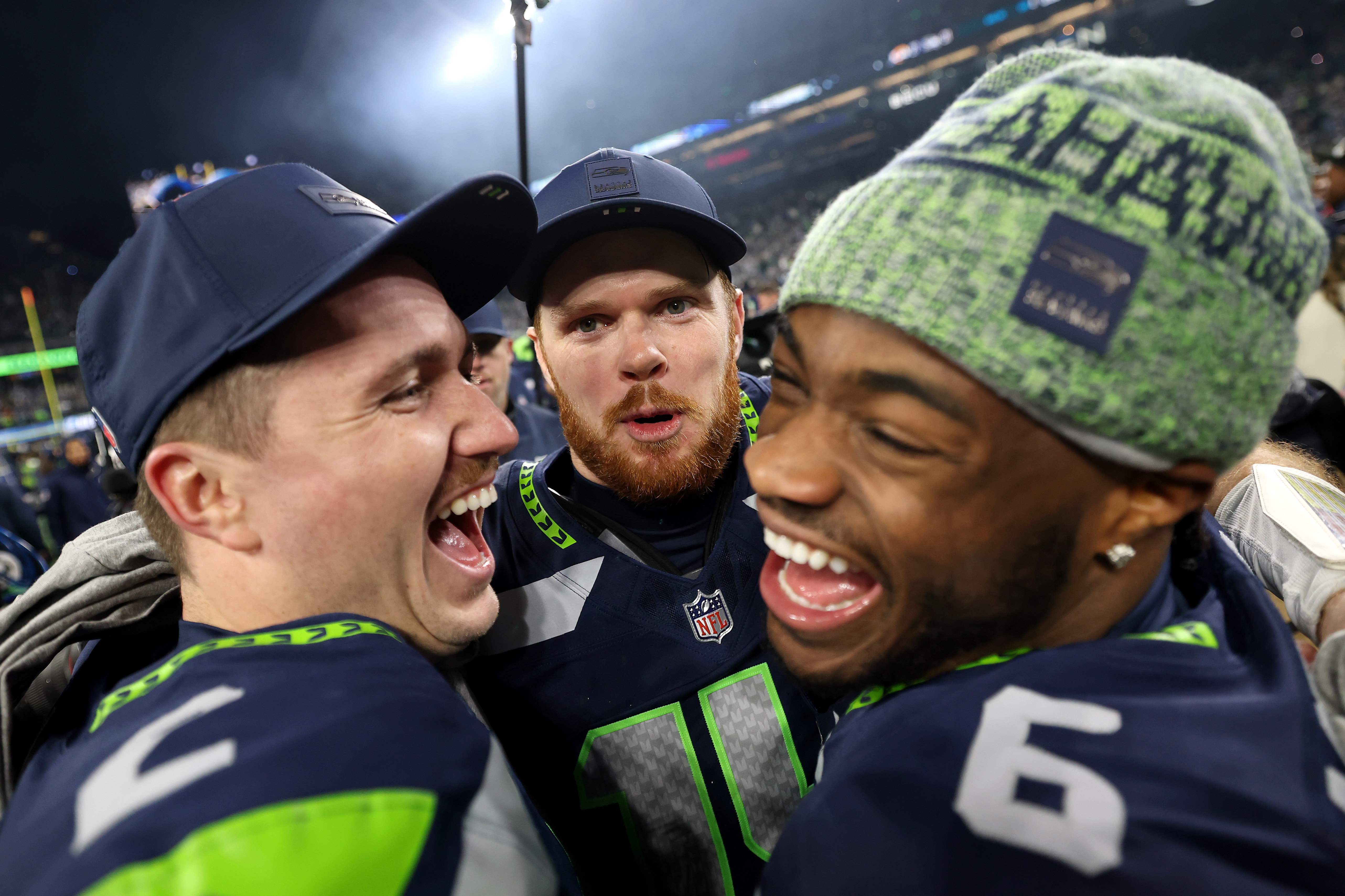 Sam Darnold (center) celebrates with fellow QBs Drew Lock and Jalen Milroe. (Steph Chambers/Getty Images)