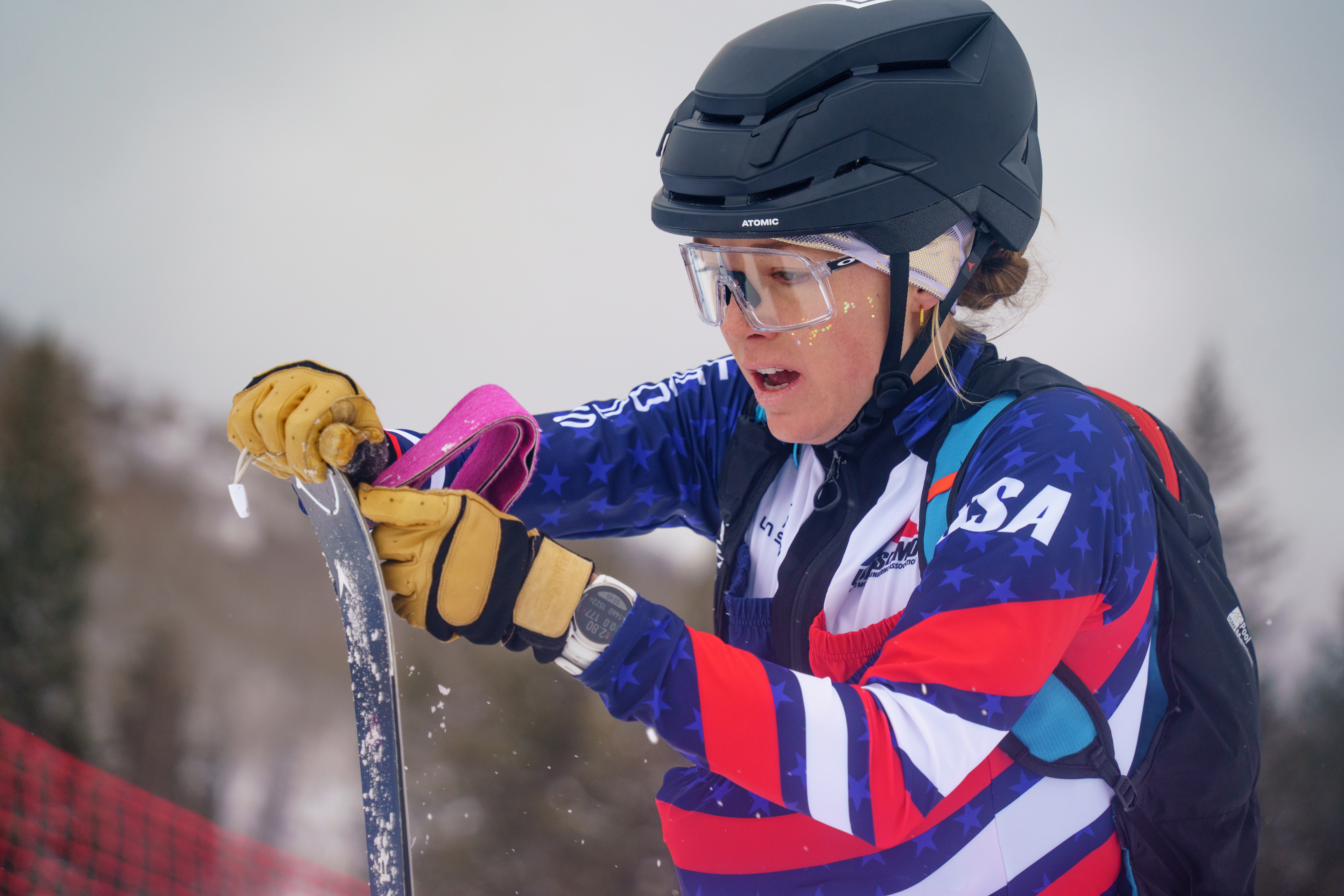 Anna Gibson puts skins on the bottom of her skis, which is all part of the only new sport at the Milano Cortina Olympics, ski mountaineering. (Courtesy of Owen Crandall)