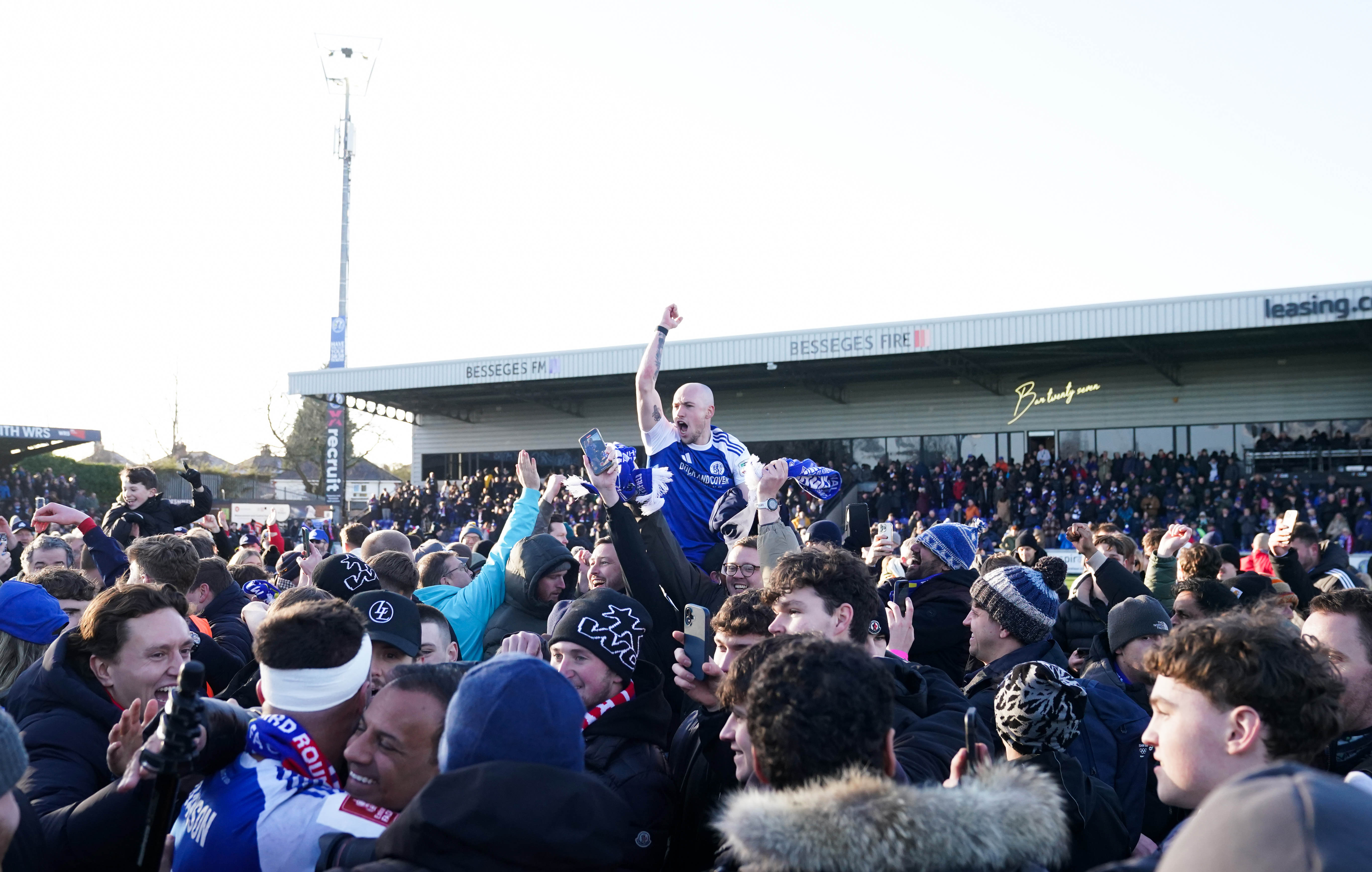 Macclesfield players celebrate with supporters after the victory. (Martin Rickett/PA Images via Getty Images)