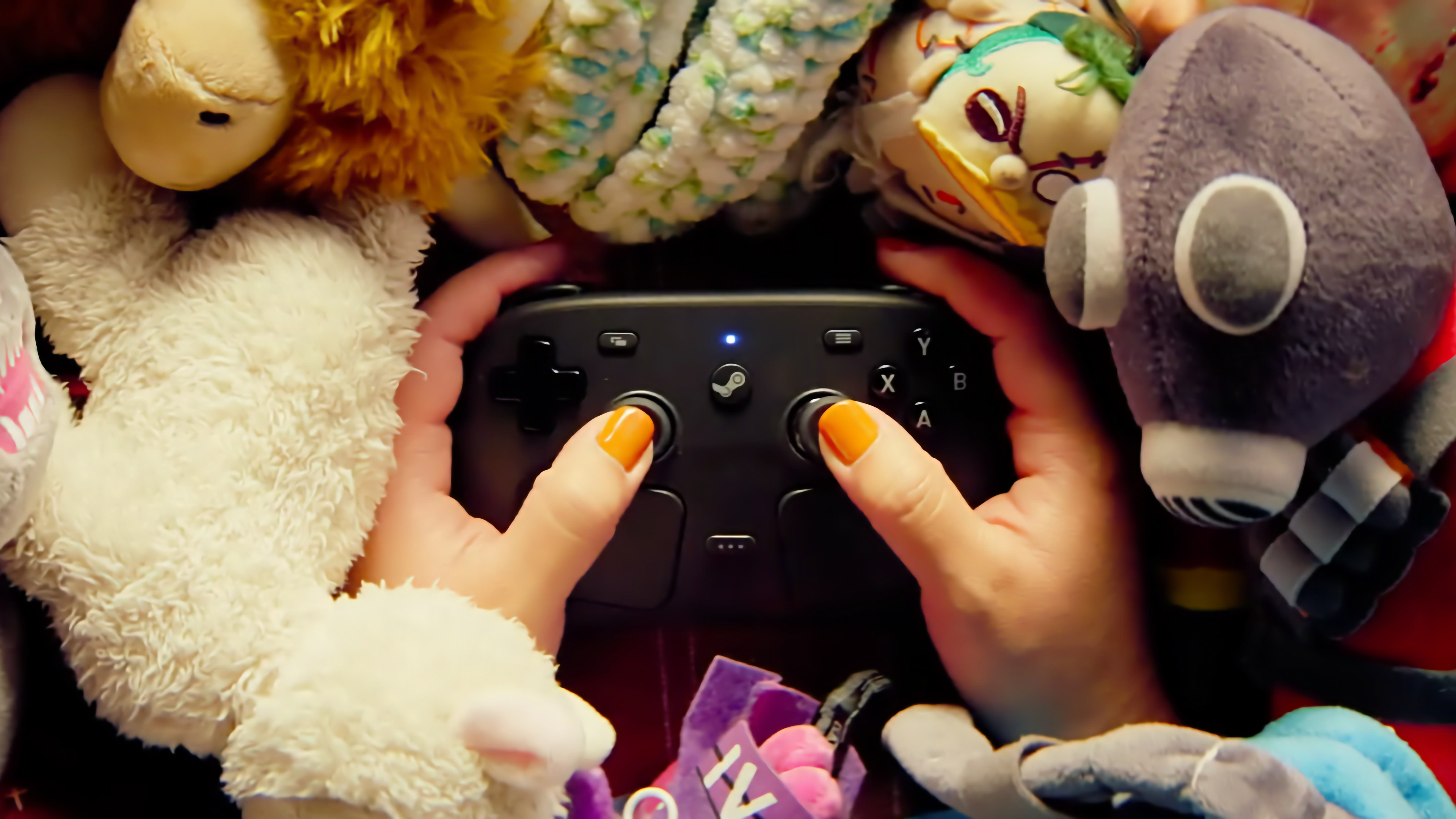 Someone holding a Steam Controller in a pile of plushies.