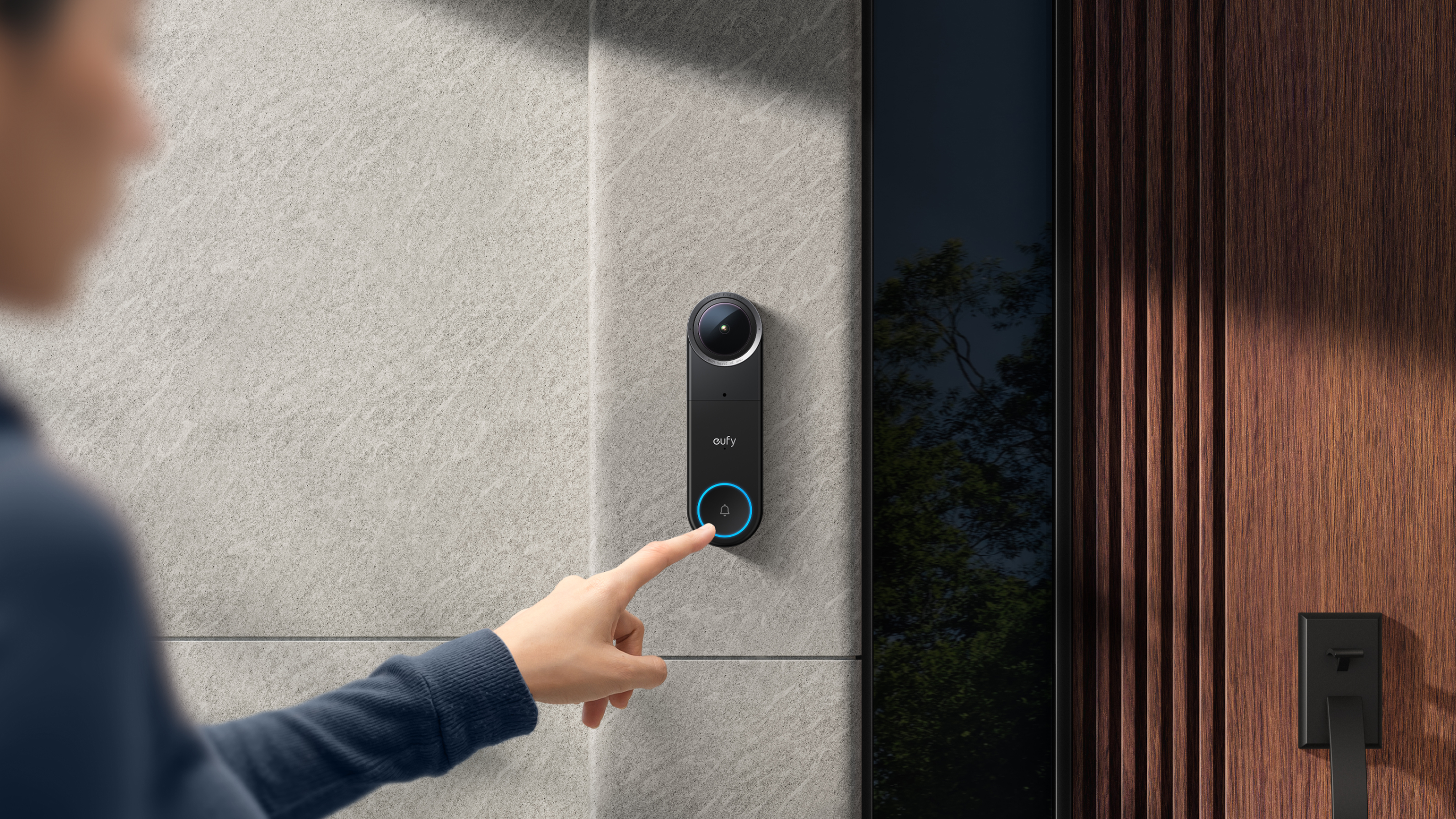 A person reaching their finger to touch a smart doorbell