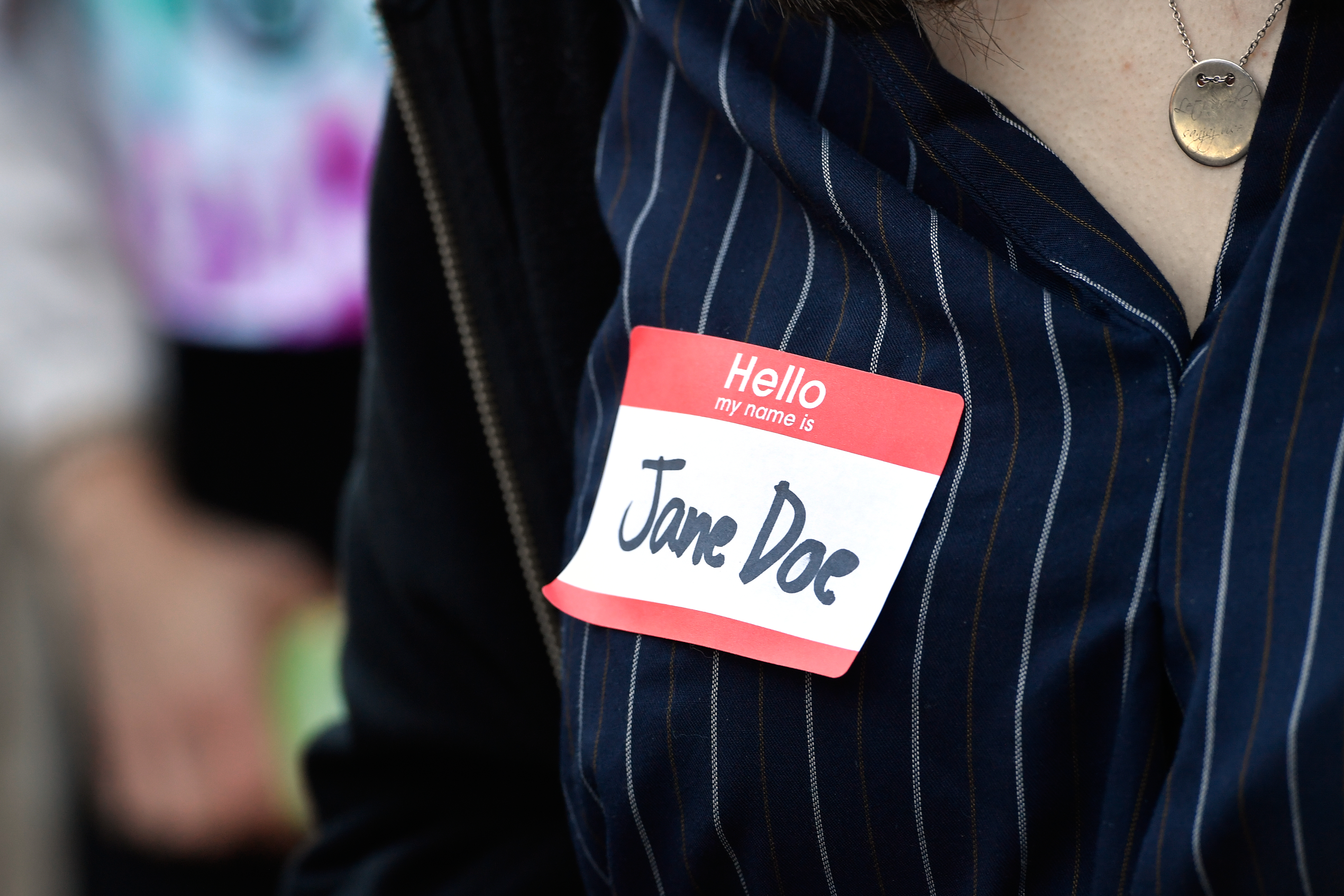 An attendee at the October 5 protest in Ithaca wears a name tag reading: Jane Doe. 