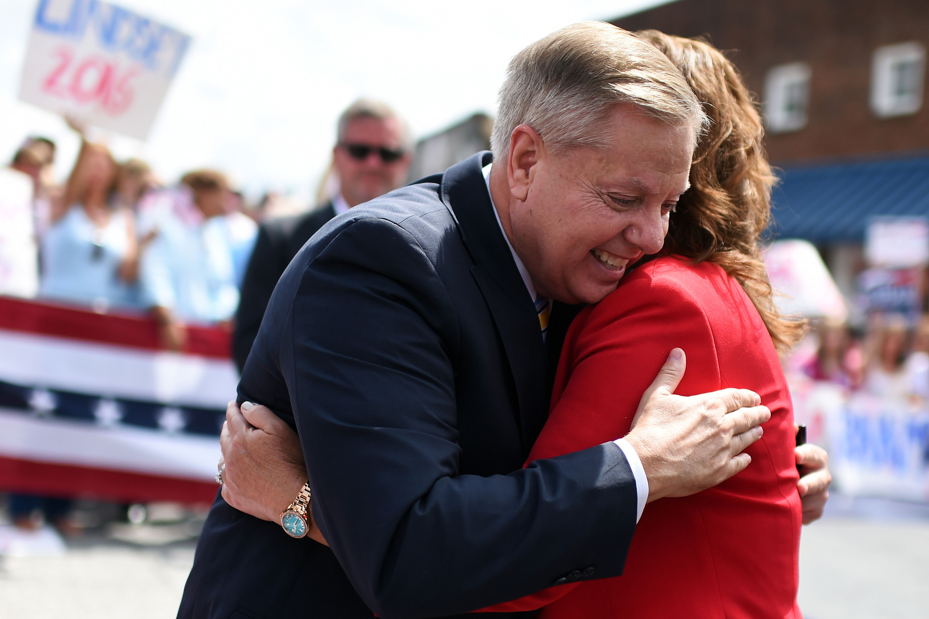 A man and a woman hug.