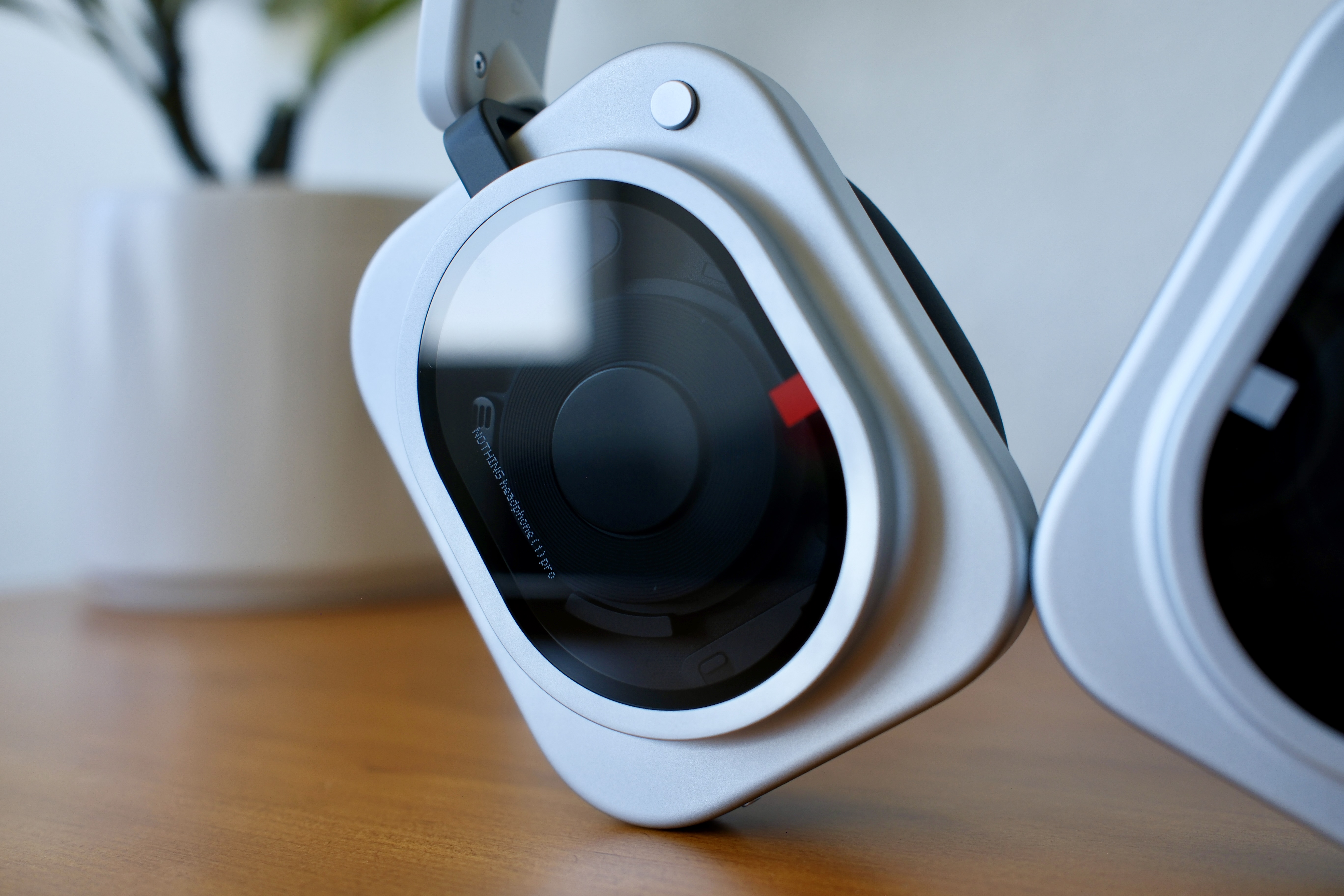 A close-up of one glass earcup of the Headphone 1 Pro