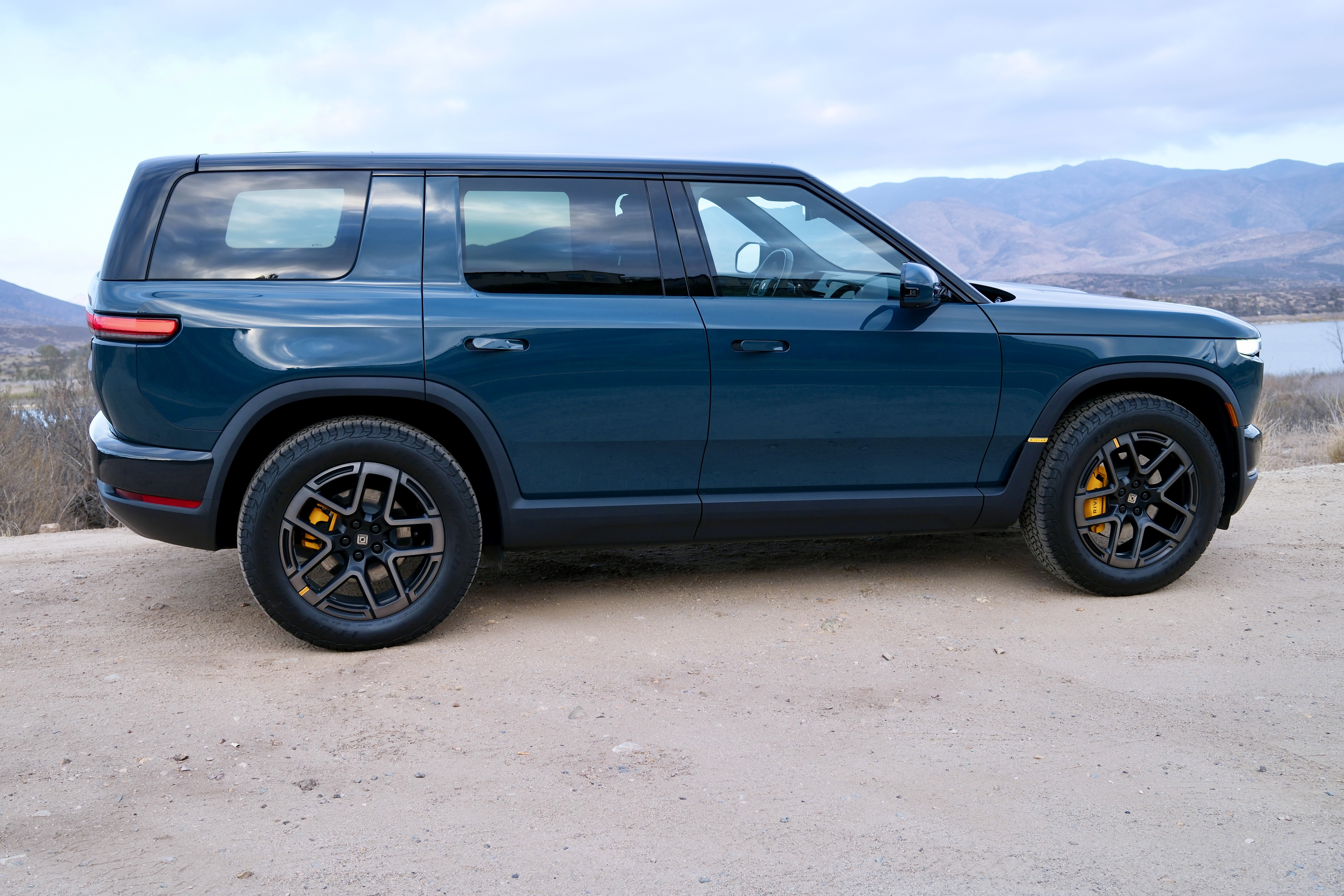 Rivian R2 parked next to a lake